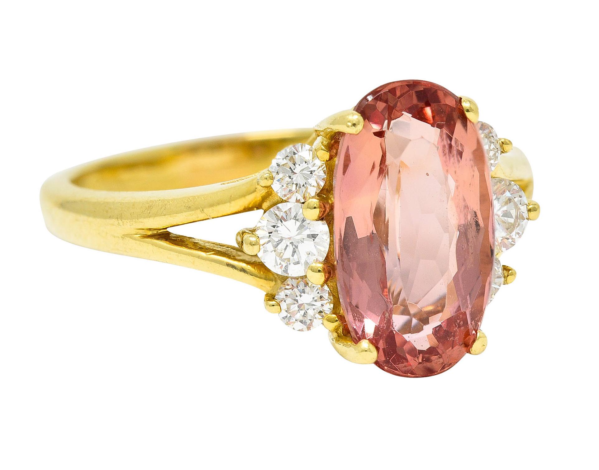 Featuring an oval mixed cut imperial topaz weighing approximately 2.65 carats

Transparent with pinkish peach color with strong saturation North and South

Basket set and flanked by round brilliant cut diamonds

Weighing in total approximately 0.30