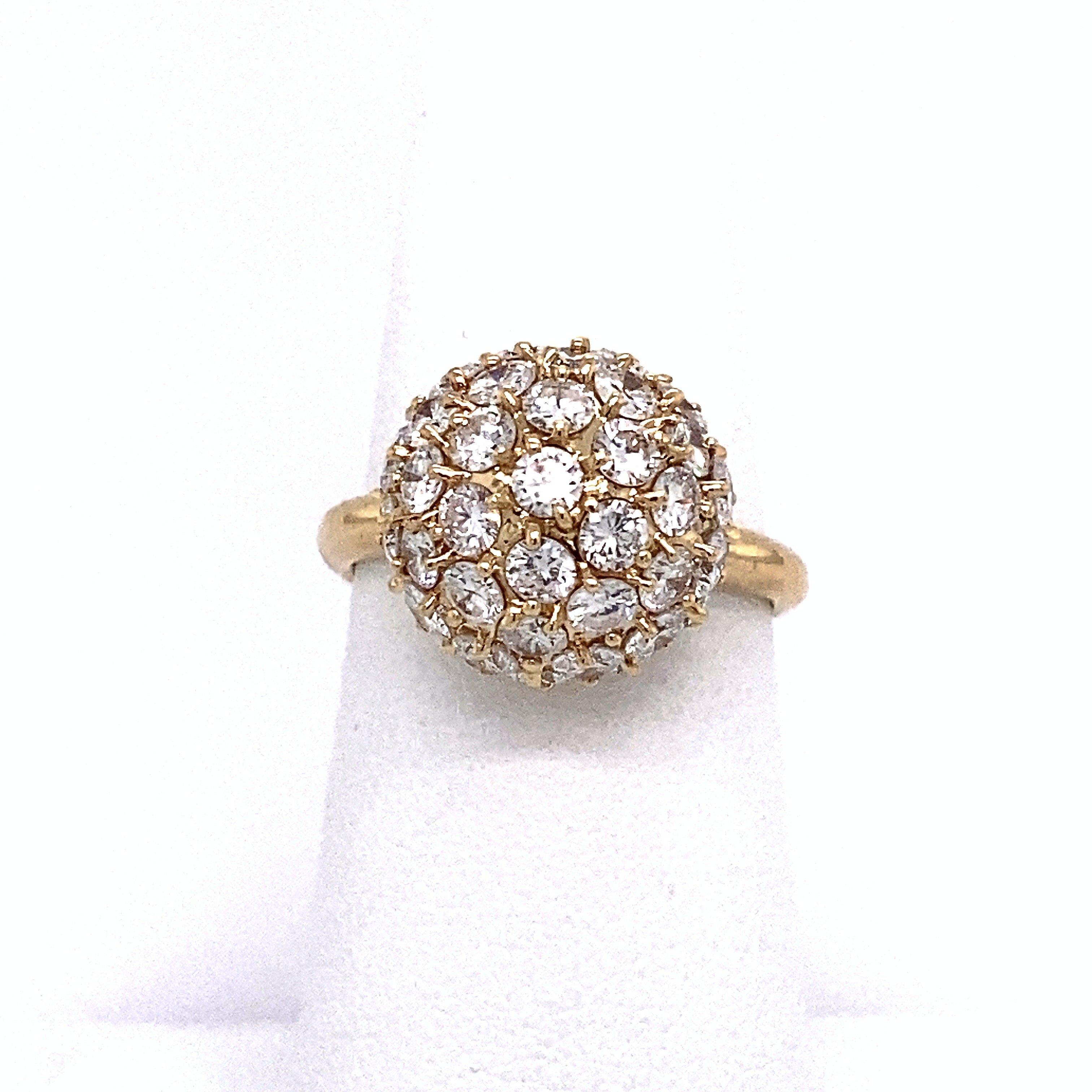 This vintage 1960's bombe ring is crafted in 18KT yellow gold and covered in 2.95CT sparking round diamonds, D-F Color, VS clarity. The ring is size 6.25 and can be resized. The top of the ring measures 13.2mm round and  9mm deep with a 2.6mm wide
