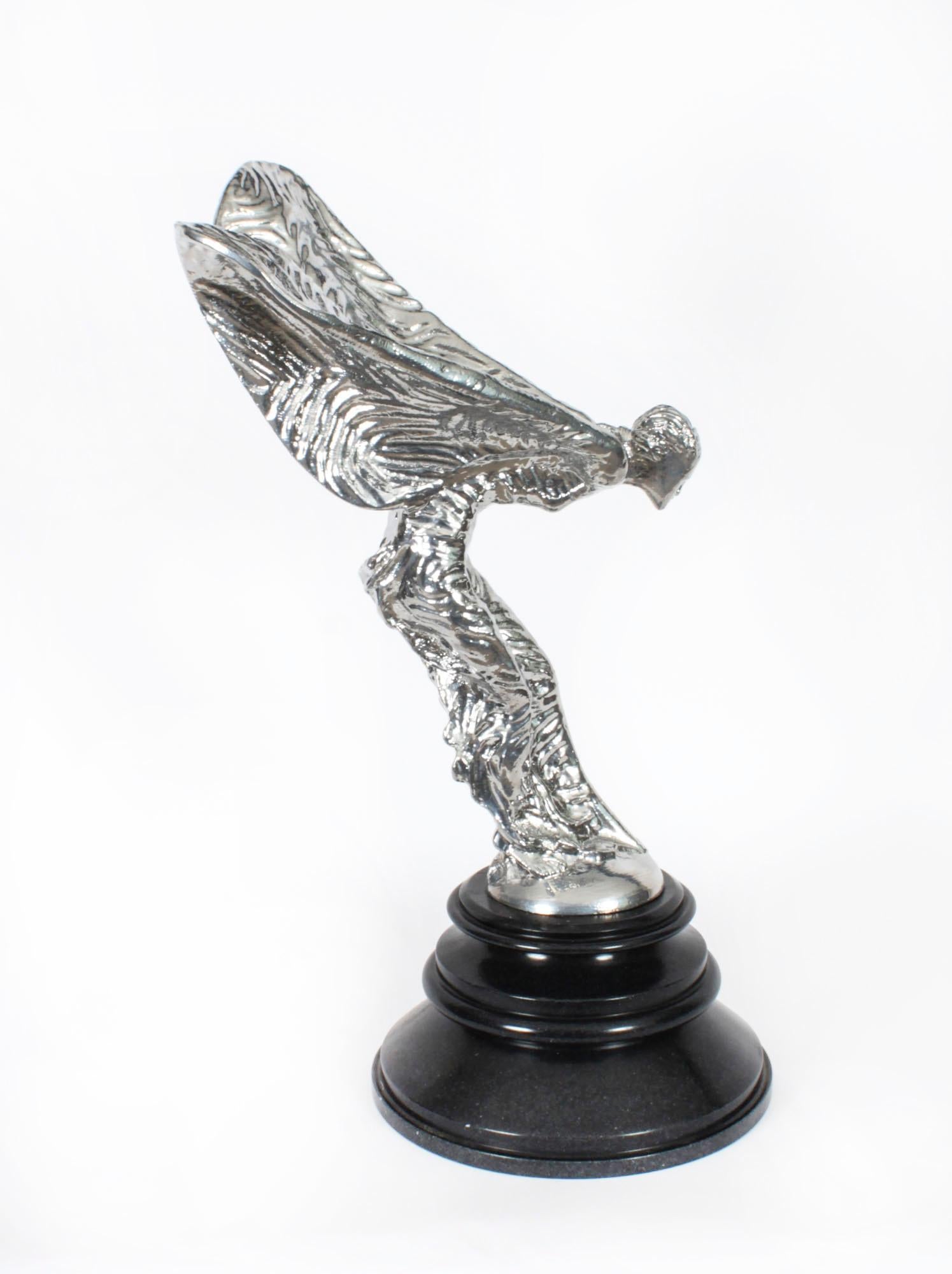 A large vintage decorative Rolls Royce silvered bronze sculpture, The Spirit of Ecstasy, dating from the mid 20th century.

The winged maiden was designed by Charles Robinson Sykes (1875-1950), and she stands on an attractive round black marble