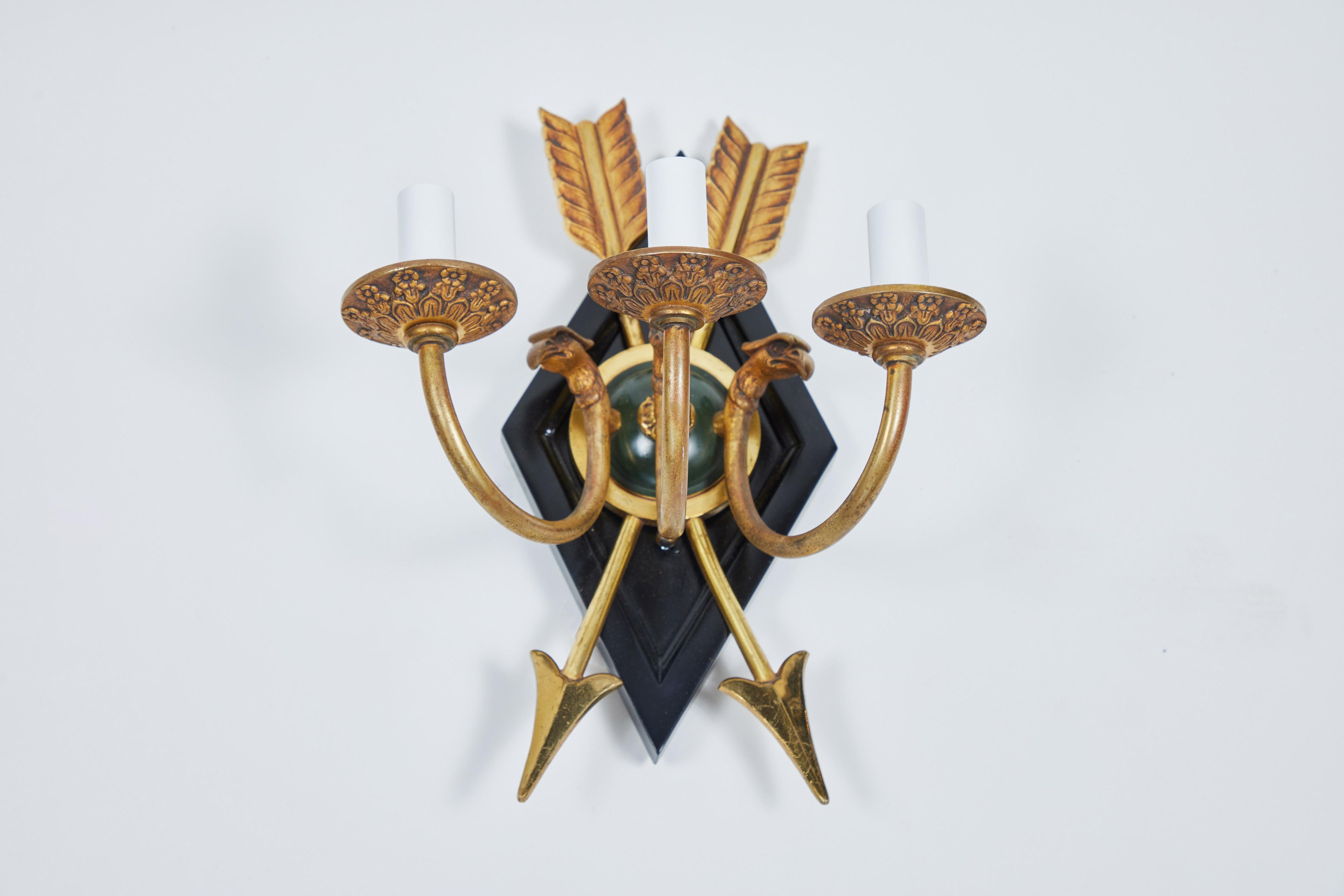 Vintage 3 arm sconce with brass arrow and eagle design brass arrow and eagle design mounted to a new wood diamond shaped back plate that has been painted black, newly rewired.
 