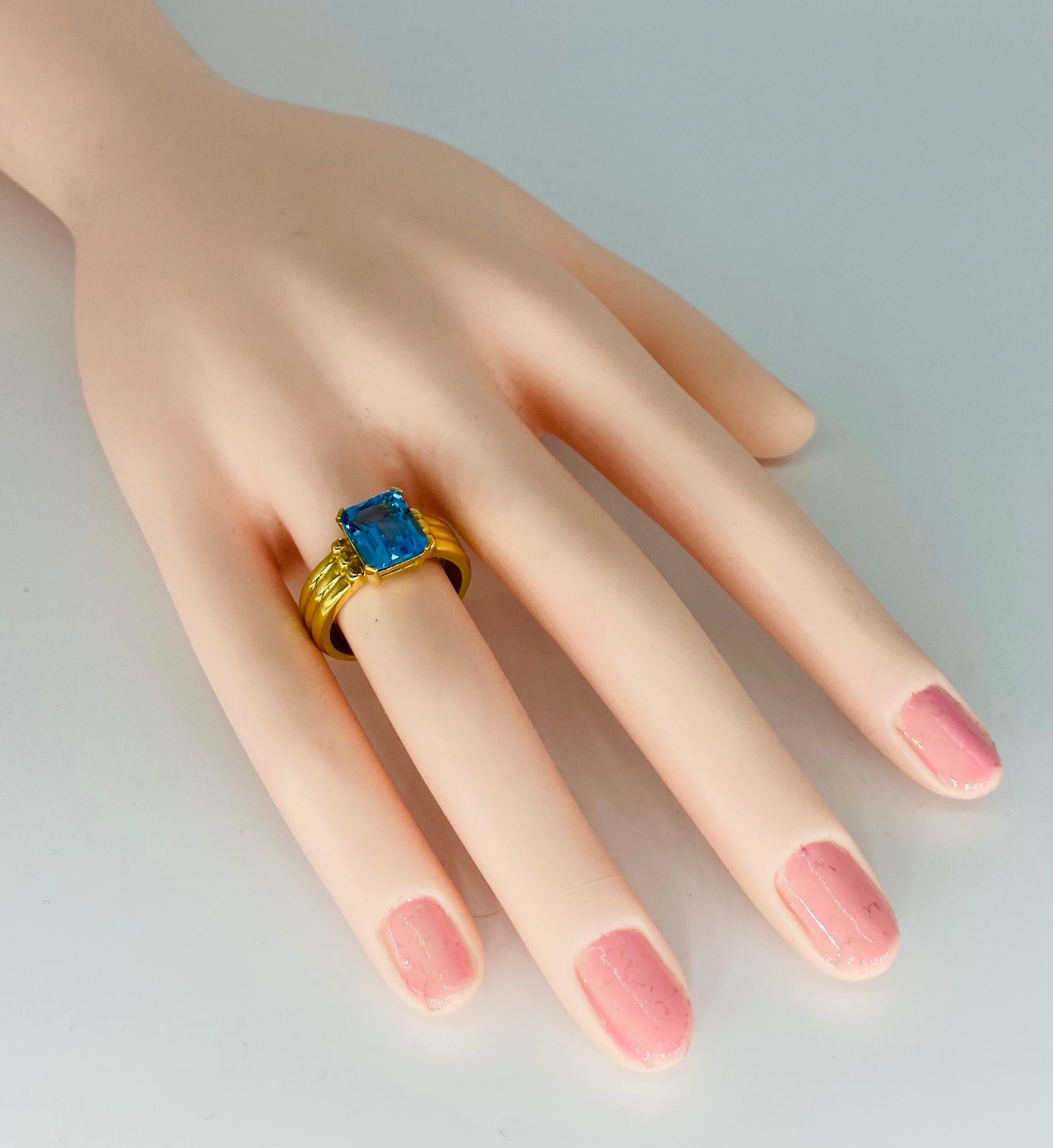 Vintage high quality 3 Carat Blue Topaz Emerald Emerald Cut Ring 18k Gold. The ring features a center 3 carat blue topaz measuring 10mm X 8mm and is a size 7.5
The ring is made in 18k solid gold weighting approx 7.5 grams 