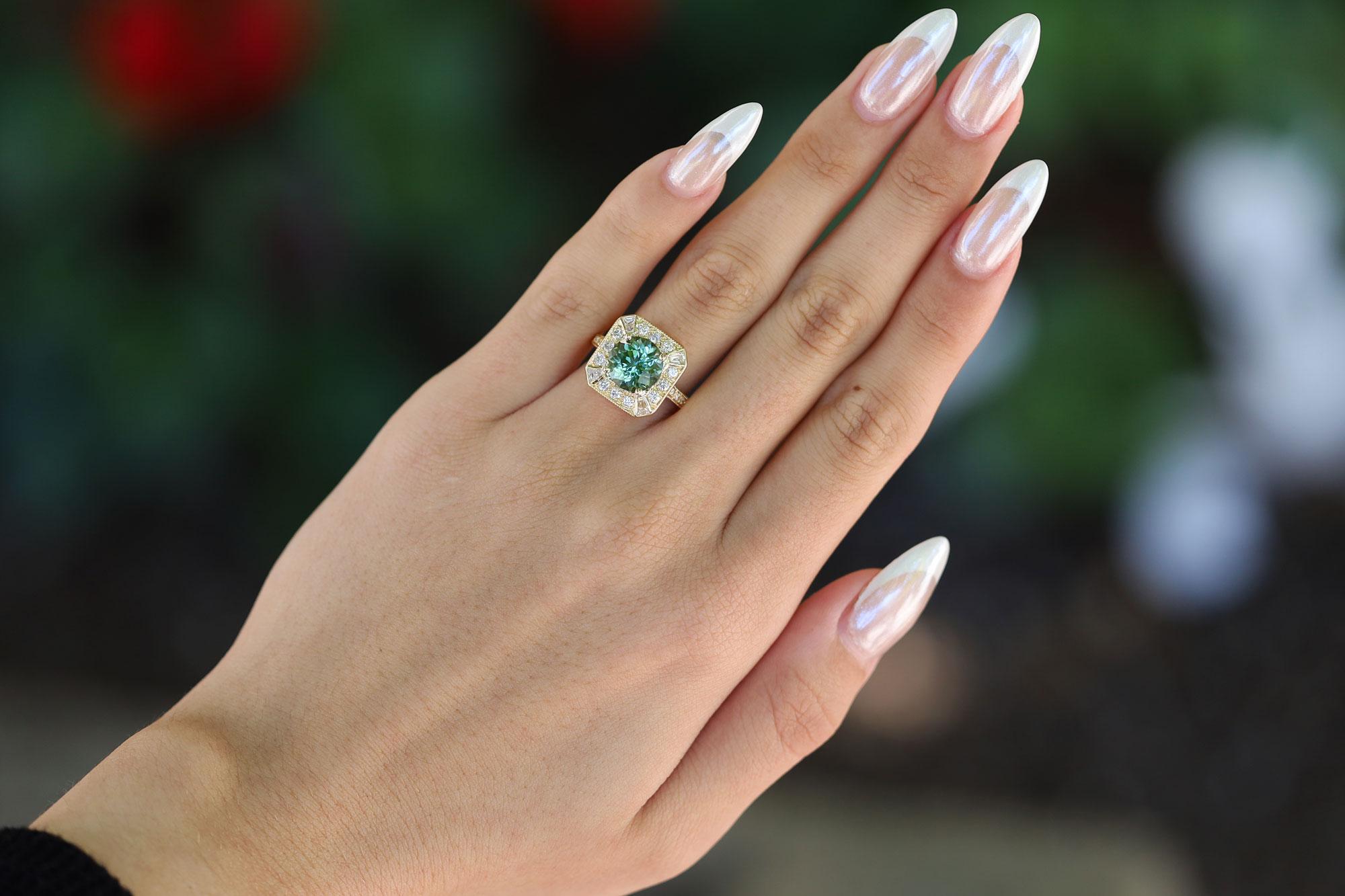 Centered by a captivating, vivid mint green tourmaline, this alluring gemstone engagement ring postures a striking statement. A vintage heirloom bringing 80's glam and an Art Deco architectural aesthetic to your hand. The octagon geometric shape is