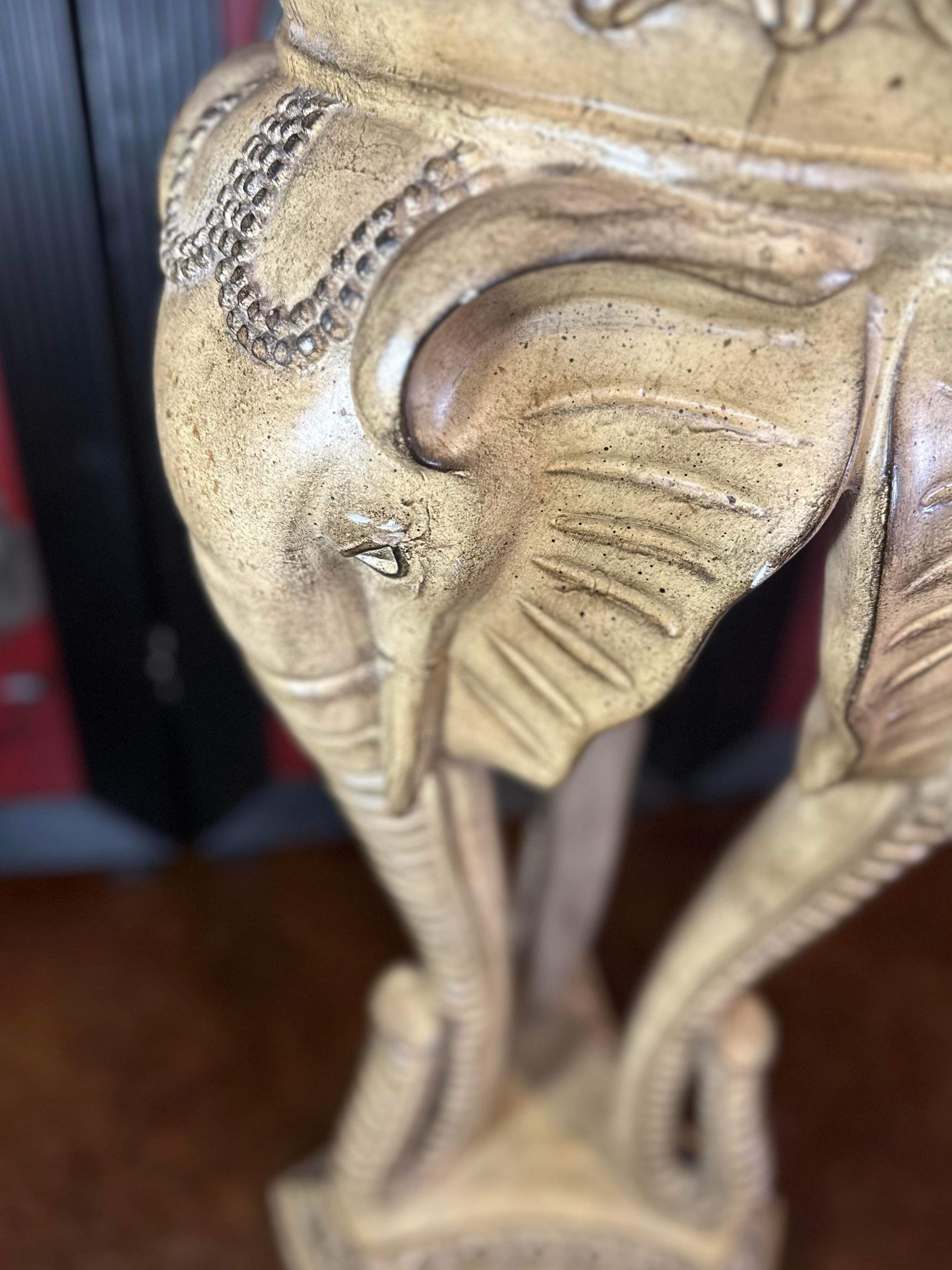 Free shipping in the continental United States. 

Statement piece. 
Could be a planter, plant stand, pedestal for art or stand alone piece of art.
Three elephant heads supported by three long, bent elephant trunks.
Elaborate foliage on the bowl, or