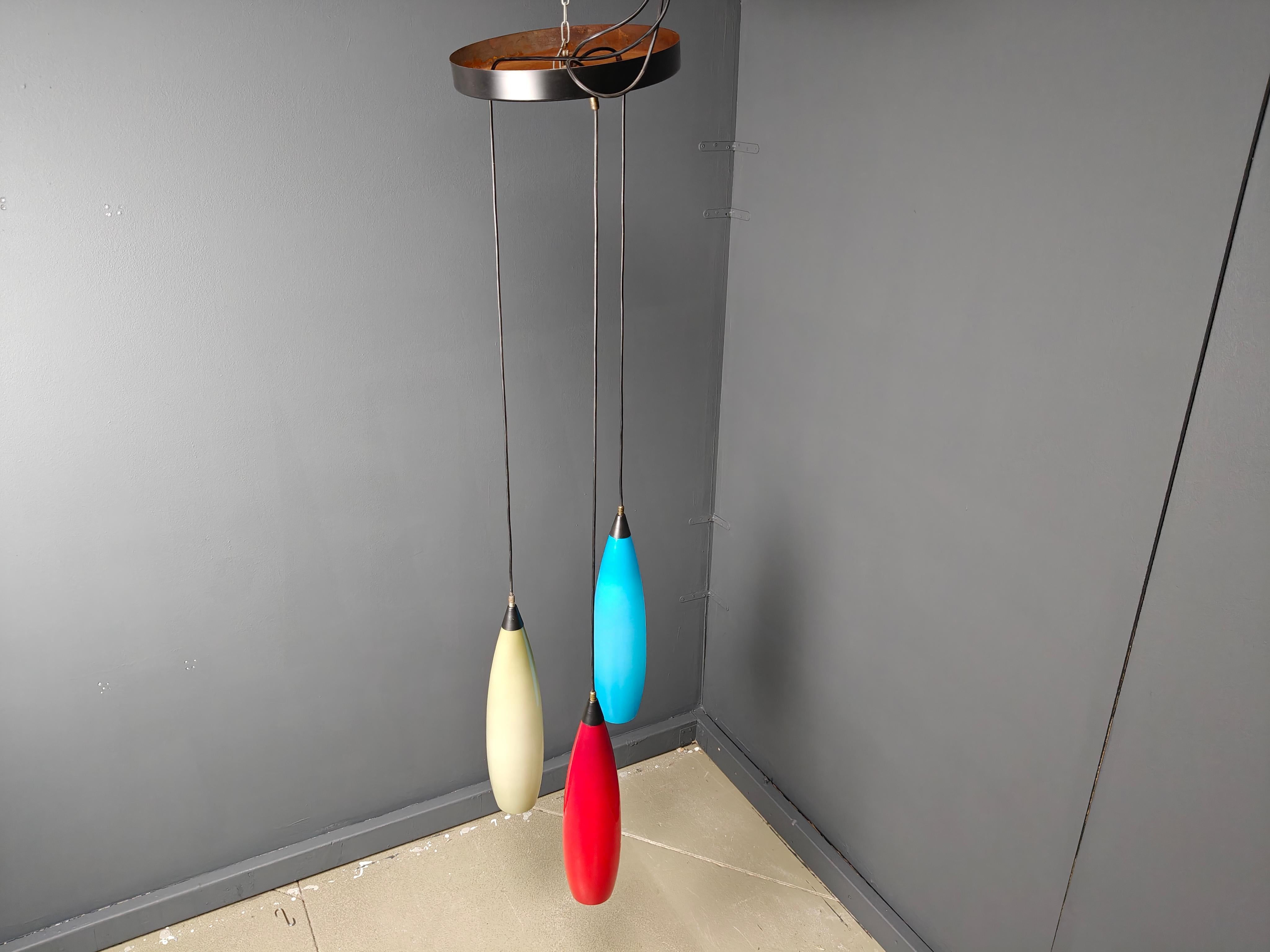 Vintage tricolor pendant lighs by Vistosi.

This chandelier or pendant lights are made out of italian glass attached to an adjustable black cord with brass/metal hardware.

Timeless and warm lights.

Tested and ready to use with regular E14 light