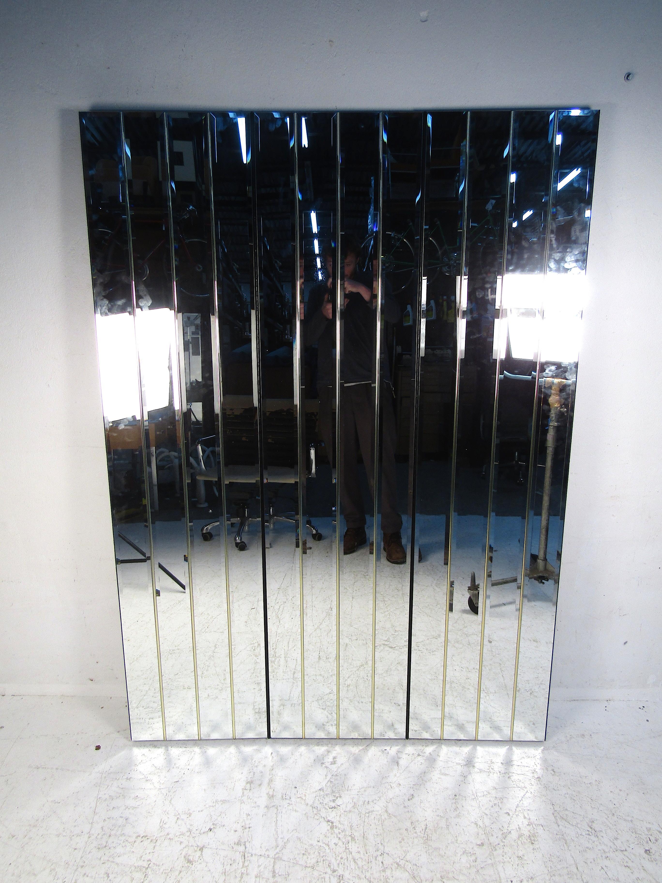 Impressive vintage three-paneled room divider. Each panel has a series of beveled mirrors on their face, with brass trim accents betwixt each mirror pane. Panels are connected with piano hinges. Unusual design, sure to be a great addition to any