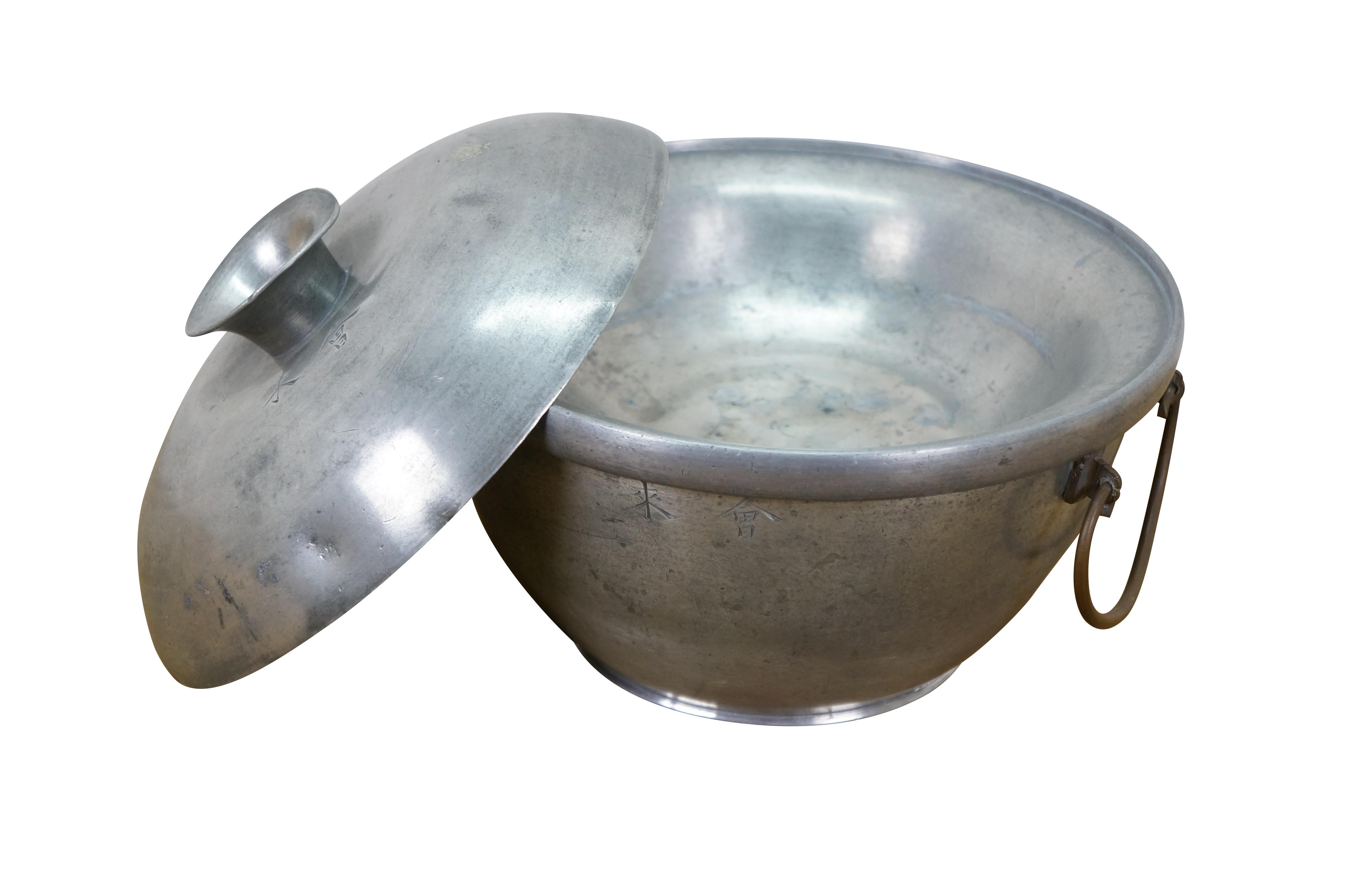 Vintage Chinese hot pot / food warmer consisting of three pieces - Round tapered base for filling with hot coals with two copper bail handles, footed plate / low bowl that sits on the upper rim of the base, and lid.

Dimensions:
8