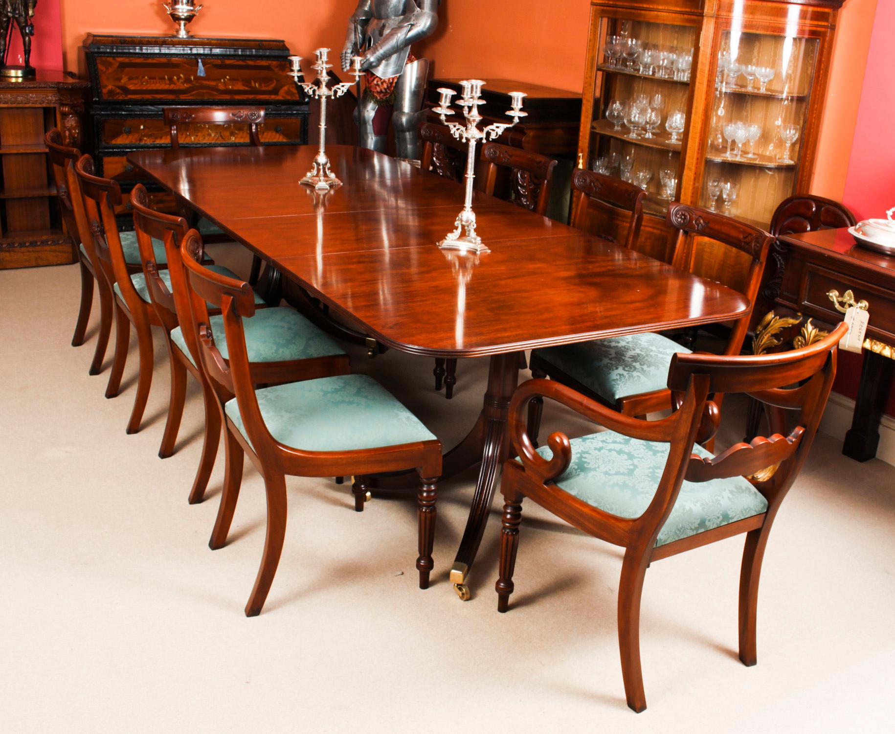 This is fabulous Vintage dining set comprising a Regency style dining table by William Tillman and a set of ten bar back dining chairs, Circa 1975 in date.

The table is made of stunning solid flame mahogany and is raised on twin 