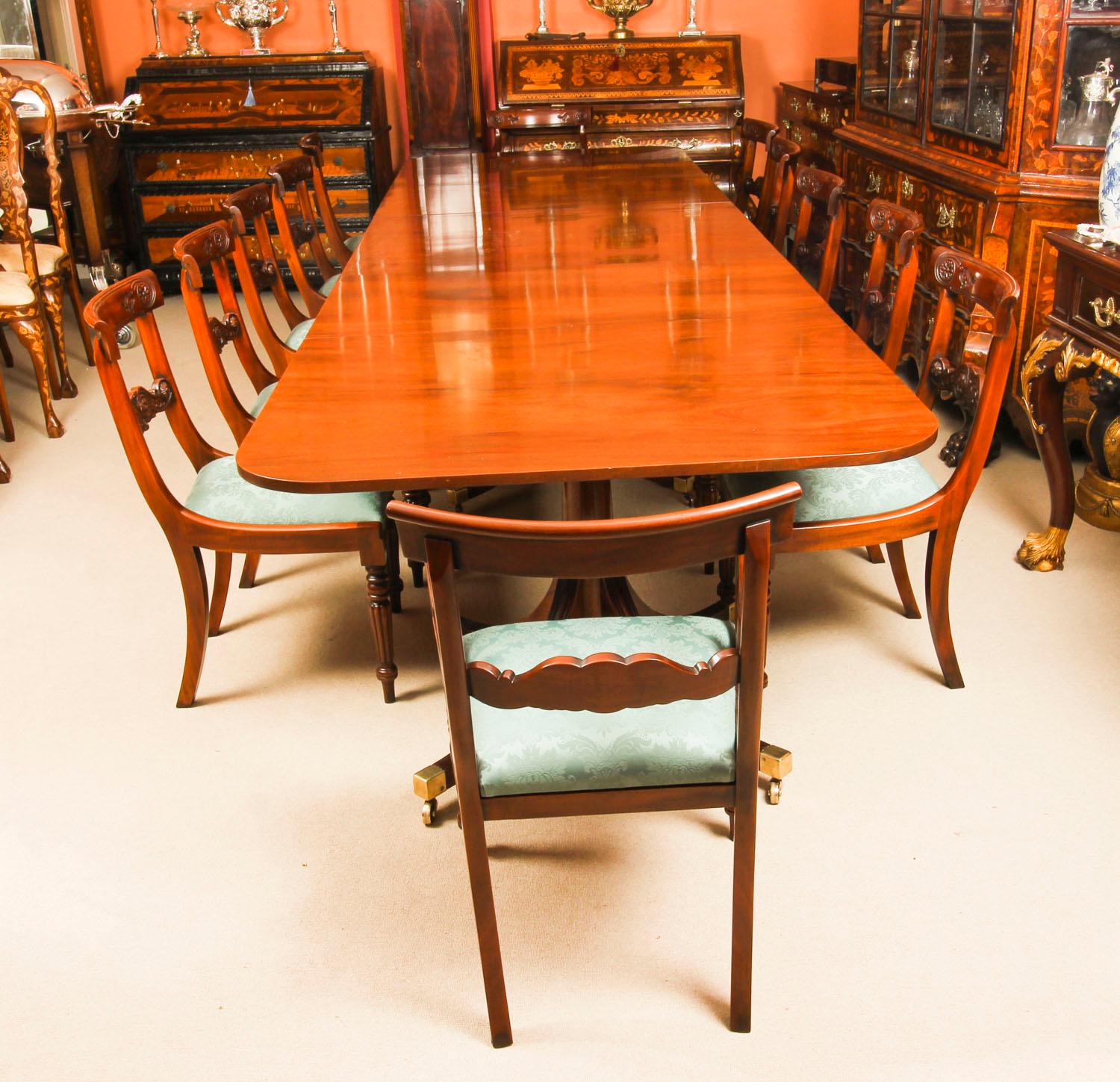 This is wonderful vintage dining set comprising a Regency style dining table by William Tillman and a set of twelve bar back dining chairs, circa 1980 in date.

The table is made of stunning solid flame mahogany and is raised on three 