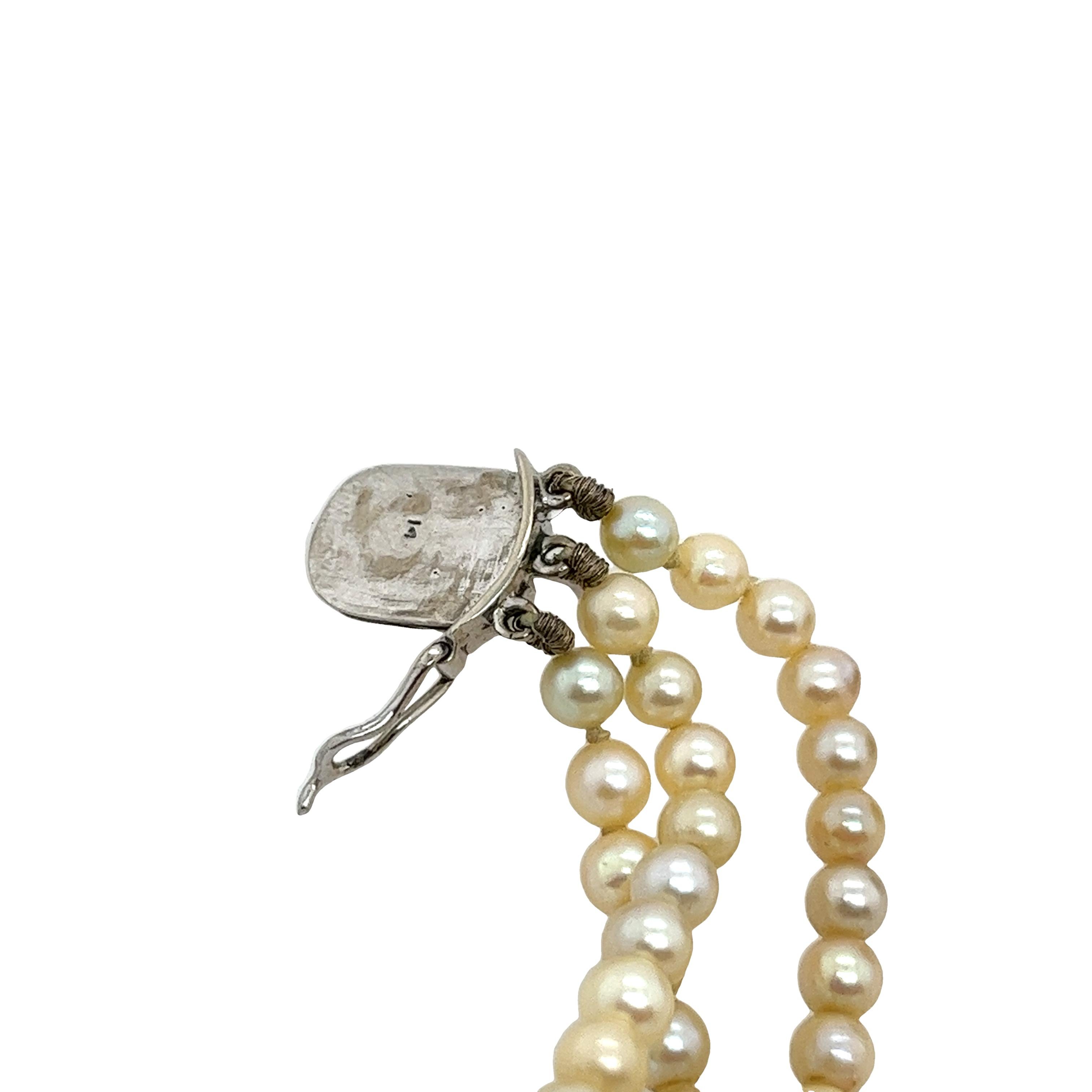 This beautiful vintage 3-row 7.3mm-3.55mm cultured pearl necklace is set with a 14ct white gold clasp 
set with 0.46ct old cut diamonds. The total length is 16.5