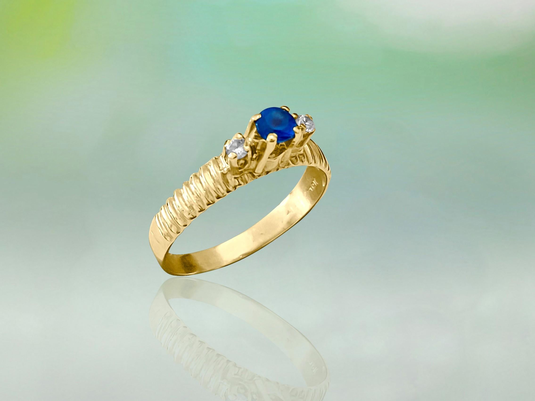 Metal: 14k yellow gold. 
Gemstone: blue sapphire. 
Side stones: diamonds. Round brilliant cut set in prongs. 100% natural earth mined diamonds. SI2 clarity and G-H color. 
Womens estate blue sapphire, diamond and gold ring.
Perfect weddings and