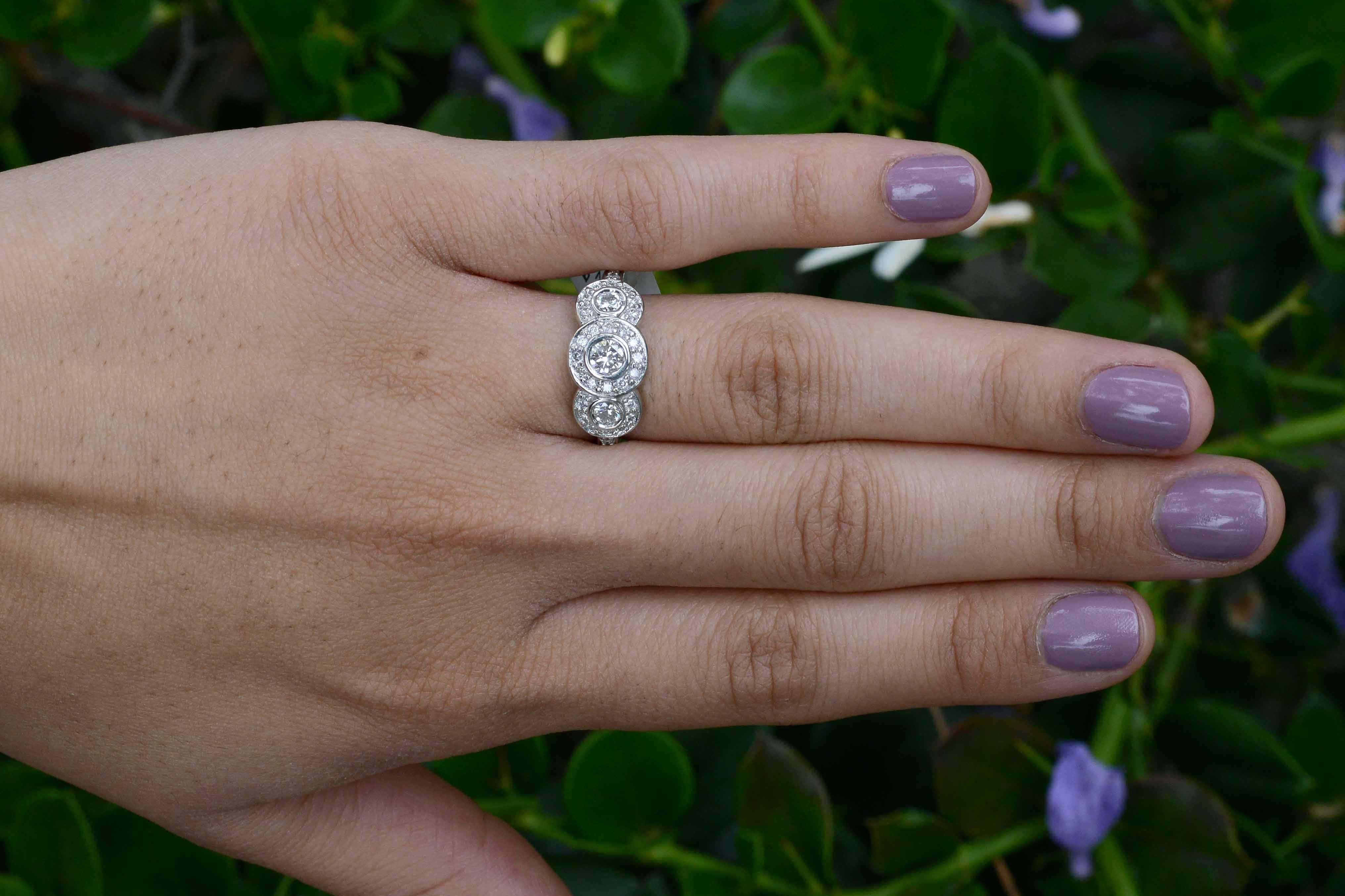 Why have only 1 halo when you can have 3? This vintage 3 stone trinity diamond engagement ring really dazzles. With nearly one carat total weight (0.89), an outstanding value with a huge amount of finger coverage and a substantial feel. The low on