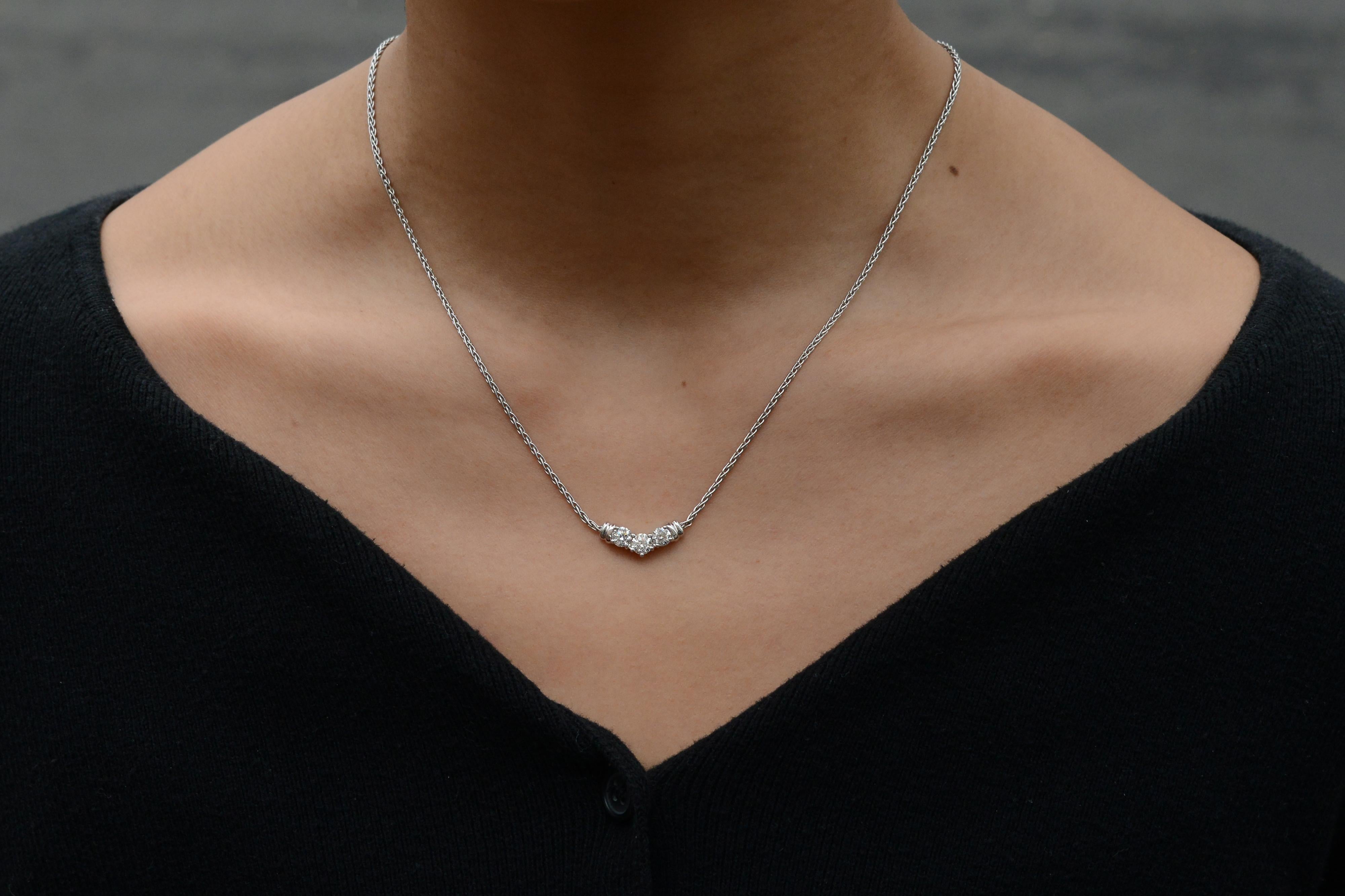 A vintage trilogy 3 stone diamond necklace. Made in the 1990s with a vintage aesthetic, this trinity necklace is crafted of sustainably-sourced 14 karat white gold, and is embellished with 3/4 carats of superior diamonds that sparkle and shine with
