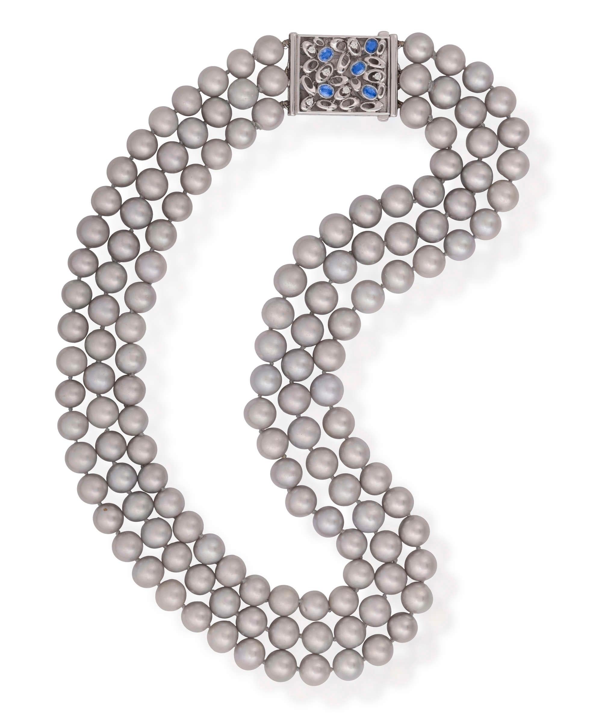 Vintage Three Strand 9.5-10.9mm Cultured Grey PEARL& DIAMOND, SAPPHIRE Necklace 18K White Gold.
Among all the pieces of jewelry, there exists one that possesses a remarkable versatility. It complements a wide range of outfits, suits various social