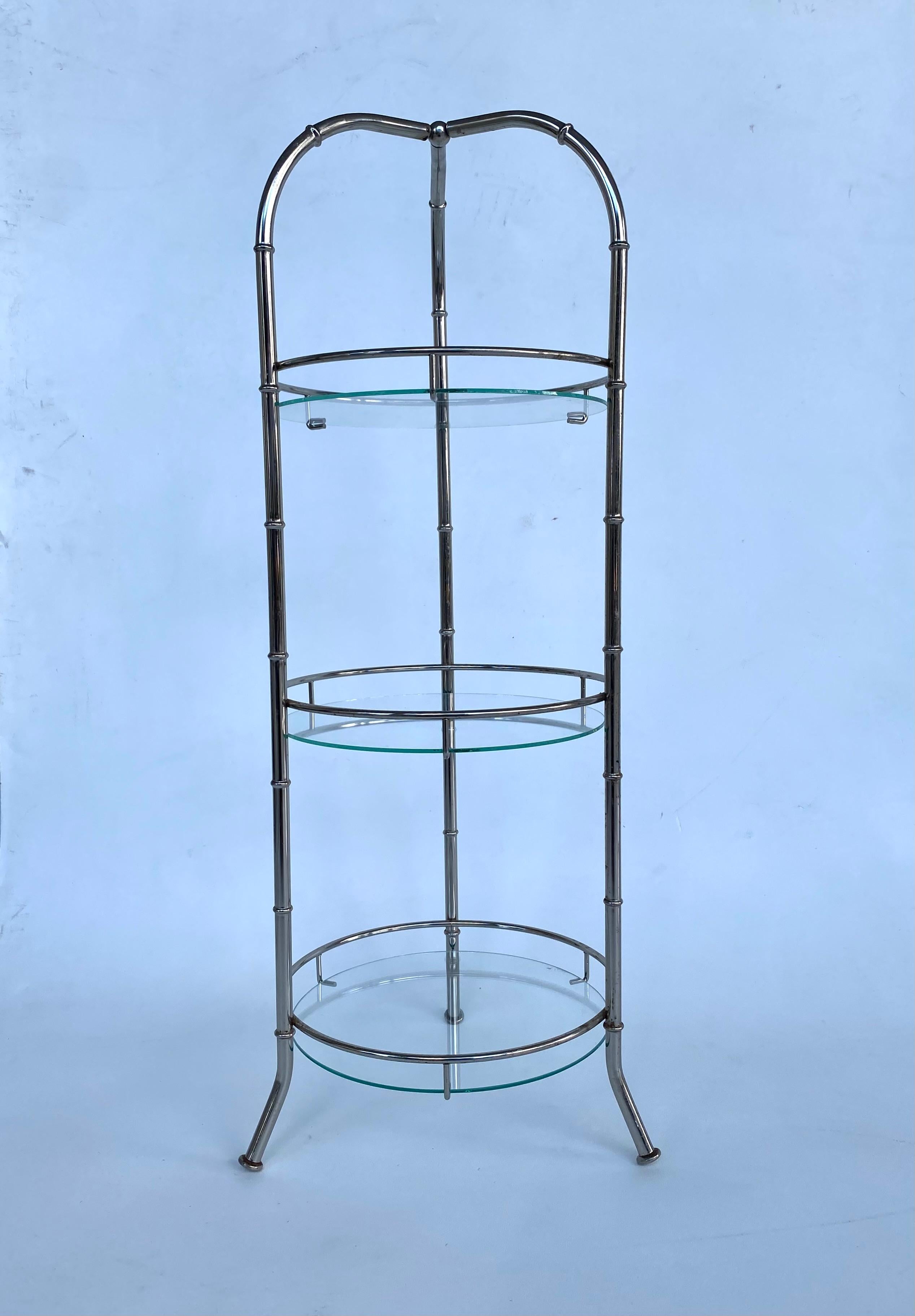 Vintage 3-tiered Chromed Carrying Dessert Cake Stand with Glass Shelves

Offered for sale is a three-tiered chromed metal and glass cake stand with an arched top and three legs. The top arches function as handles to carry the stand as needed. Each