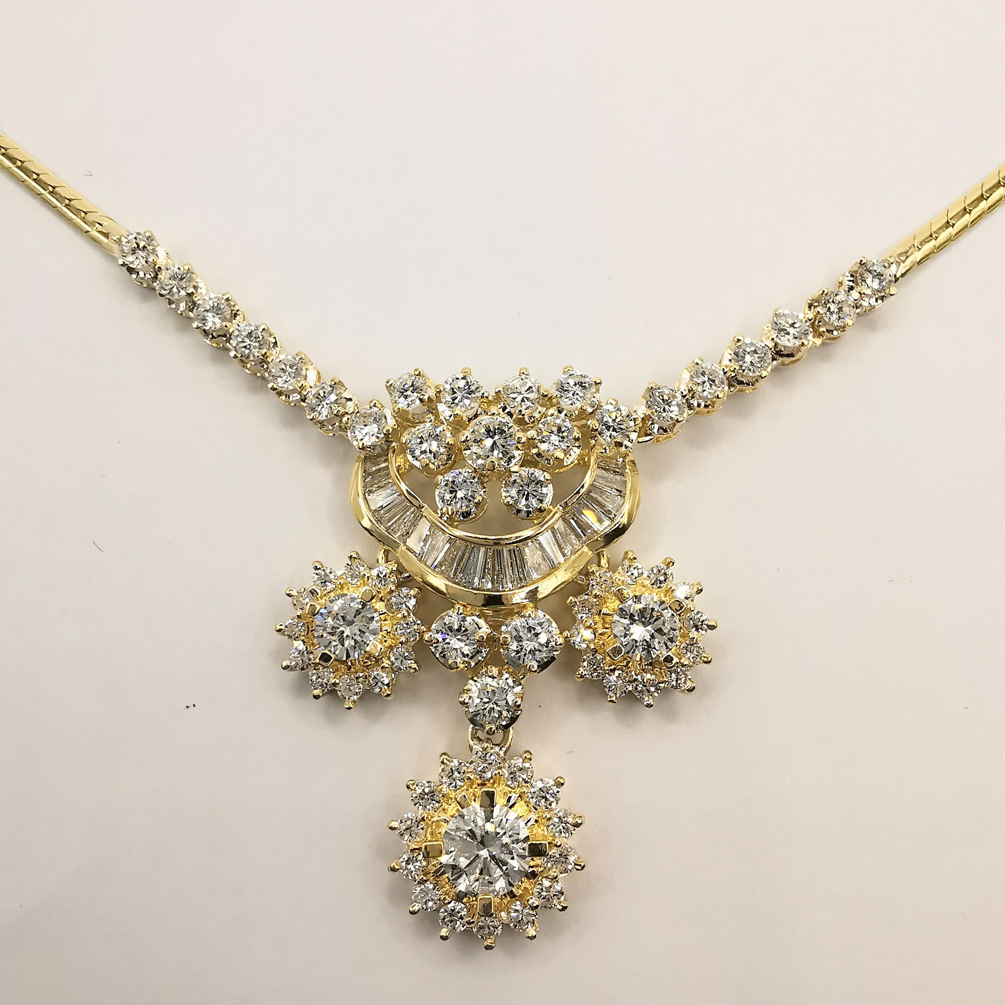 This vintage diamond necklace is a true work of art. The centerpiece of the necklace features three stunning diamonds: one round-cut diamond weighing approximately 0.376 carats, and two round-cut diamonds weighing approximately 0.34 carats each.
