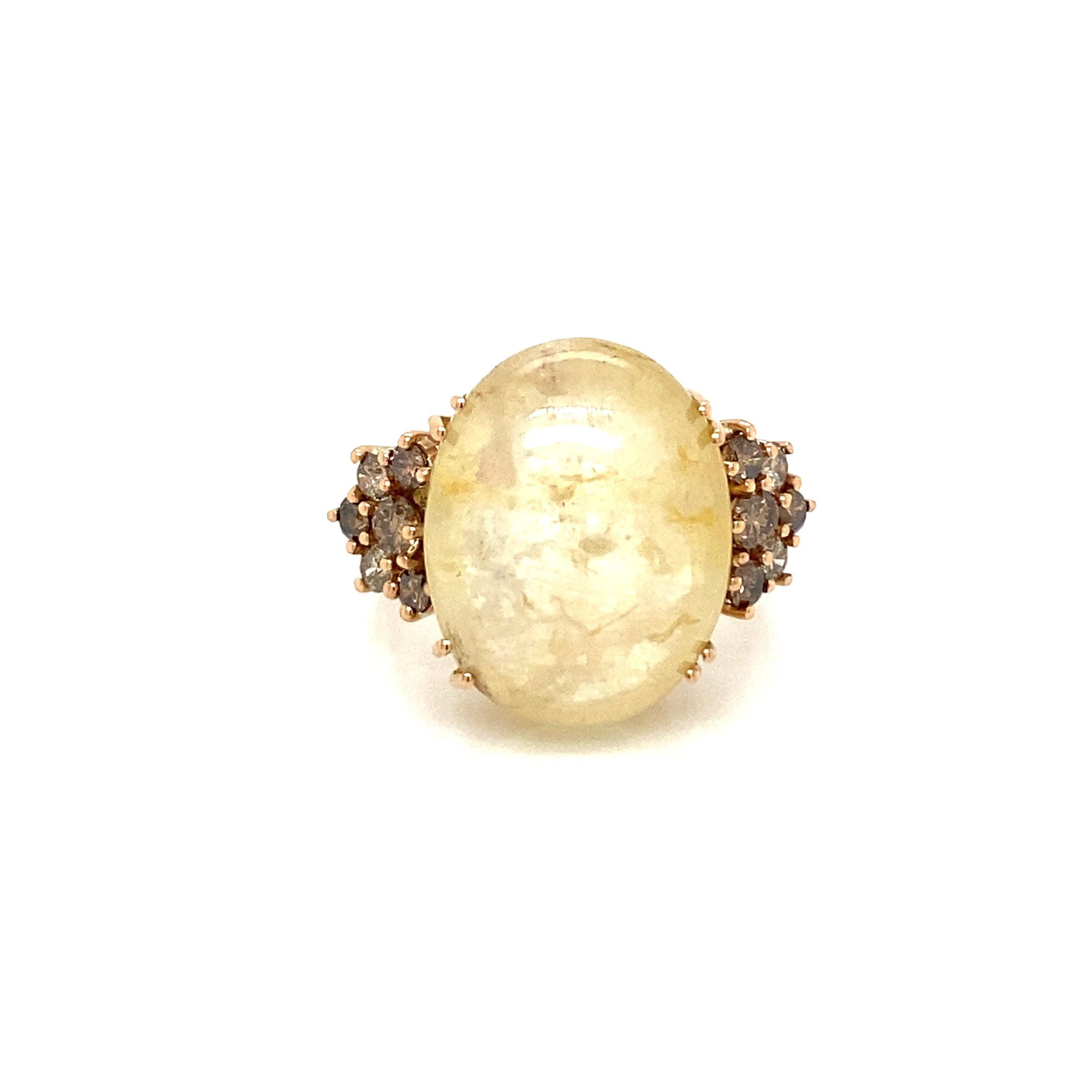 Unusual handmade 18k rose gold cocktail ring. It is set with one large Natural Sapphire cabochon shaped in the center, weight 32 carat, and surrounded by brown and white round Brilliant cut Diamonds, total weight 1 carat.

CONDITION: Pre Owned -