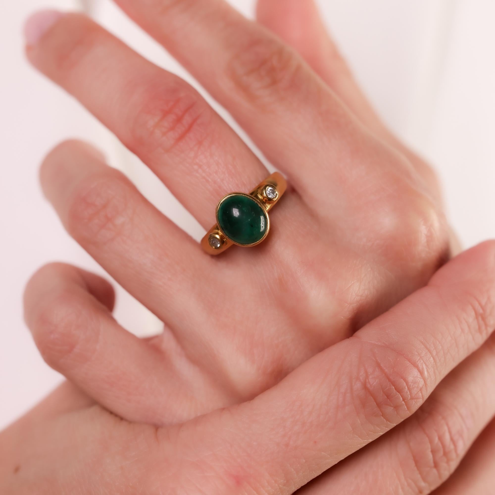 This vintage 1960s 18k yellow gold ring features a lush 3.20 carat cabochon cut emerald, accented by sparkling diamonds, for a classic and elegant look.

Center stone: Cabochon cut emerald 
Weight: Approximately 3.20 carat
Accent stone: 2 round