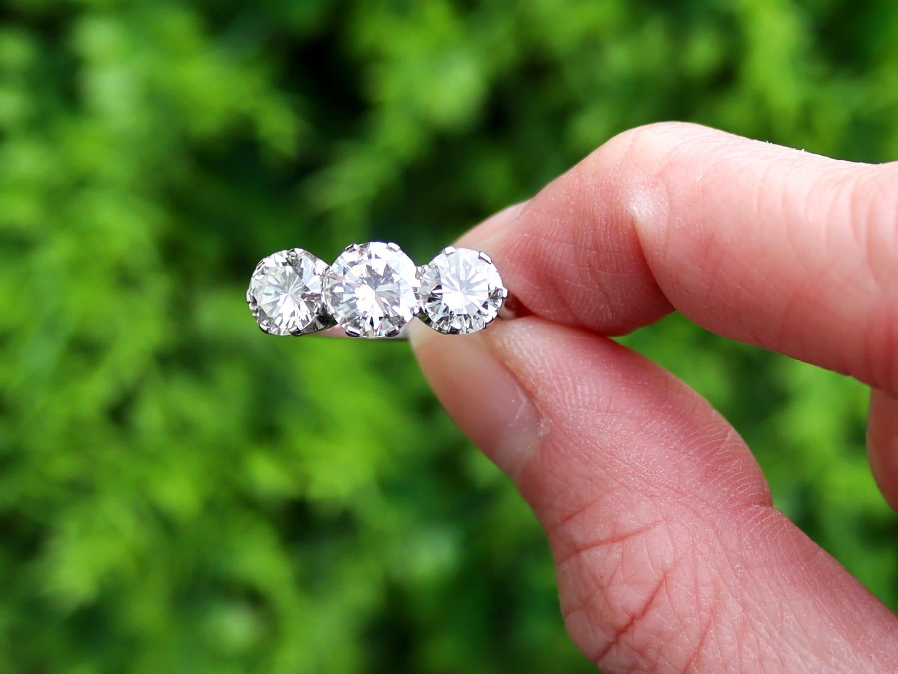A stunning, fine and impressive vintage 3.23 carat diamond and 18 karat white gold trilogy ring; part of our diverse diamond jewelry and estate jewelry collections.

This stunning, fine and impressive vintage 1960s engagement ring has been crafted