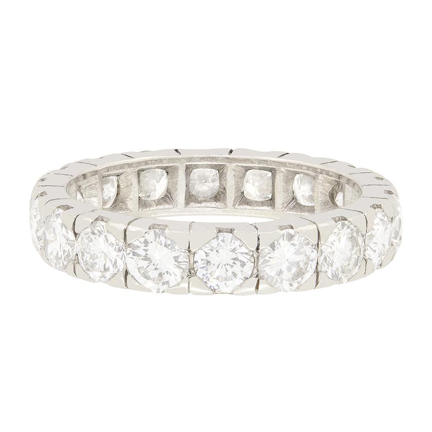 This stunning full eternity ring from the 1950s, originating in France, showcases a total of 3.24 carats of round brilliant diamonds, evenly spread across 18 diamonds adorning the band. The stones are matching in quality, with F in colour and VS in