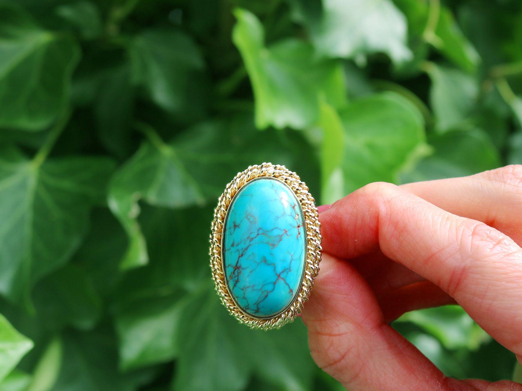 A stunning, fine and impressive 32.50 carat turquoise and 14 karat yellow gold cocktail ring; part of our vintage jewelry collections.

This stunning, fine and impressive vintage ring has been crafted in 14k yellow gold.

The pierced decorated mount