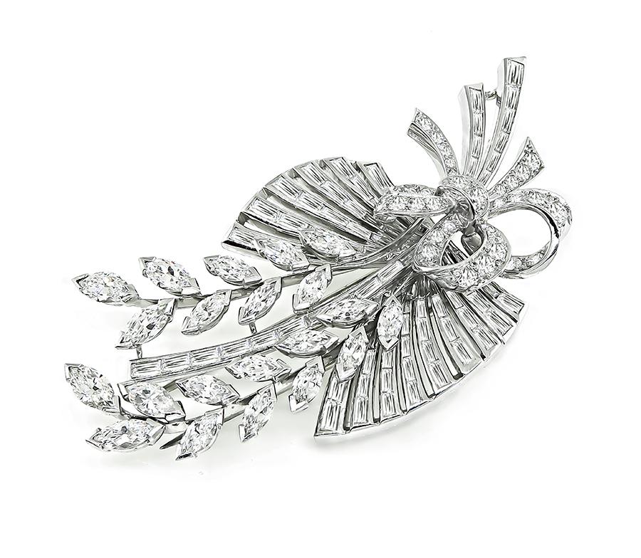 This is an amazing platinum bouquet pin from the 1950s. The pin is set with sparkling marquise, baguette and round cut diamonds that weigh approximately 3.50ct. The color of these diamonds is G with VS clarity. The pin measures 66mm by 31mm and