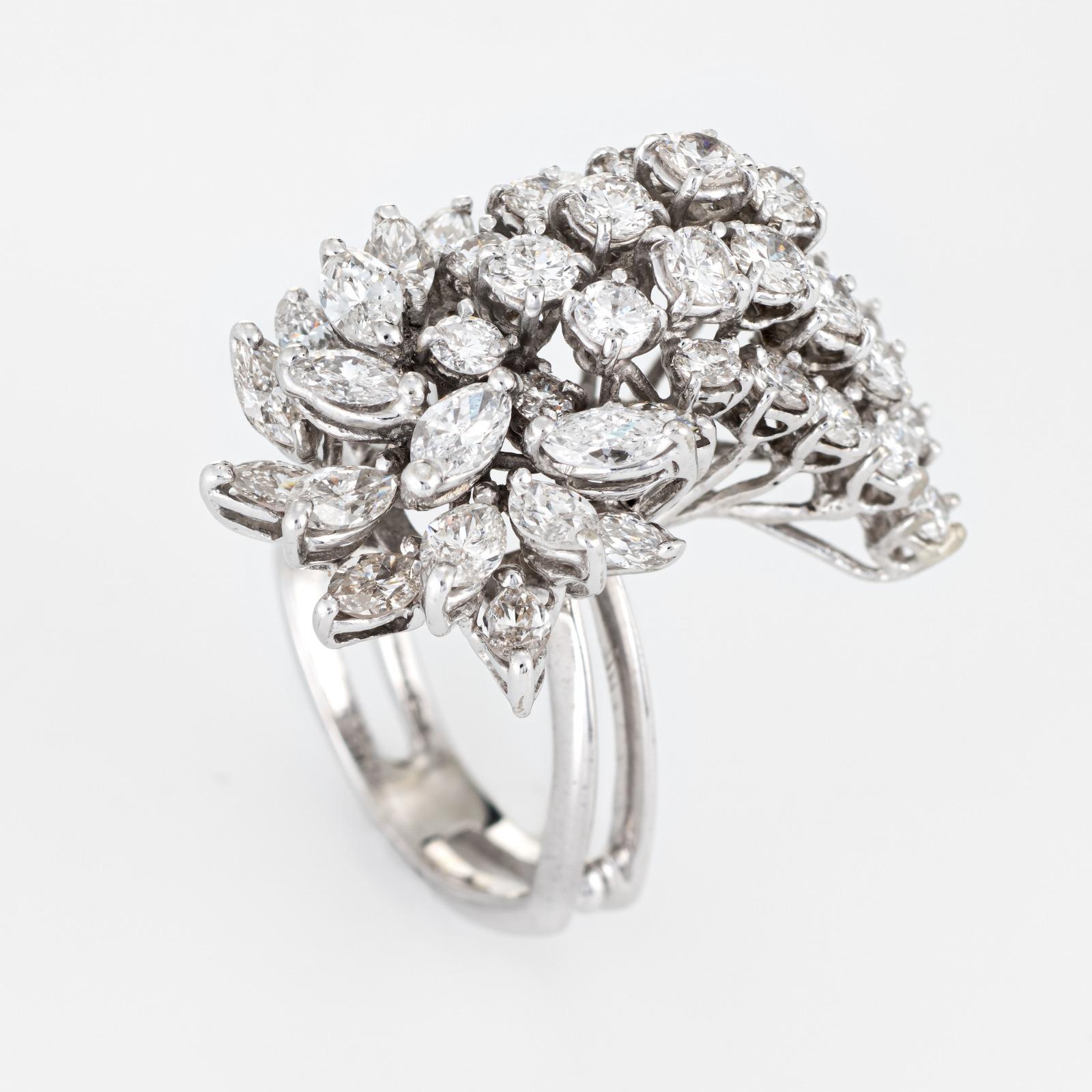 Elaborate vintage mid century cocktail ring (circa 1950s to 1960s), crafted in 14 karat white gold. 

An estimated 3.52 carats of marquise and round brilliant cut diamonds adorn the mount (estimated at G-H color and SI1-2 clarity).

The showstopper