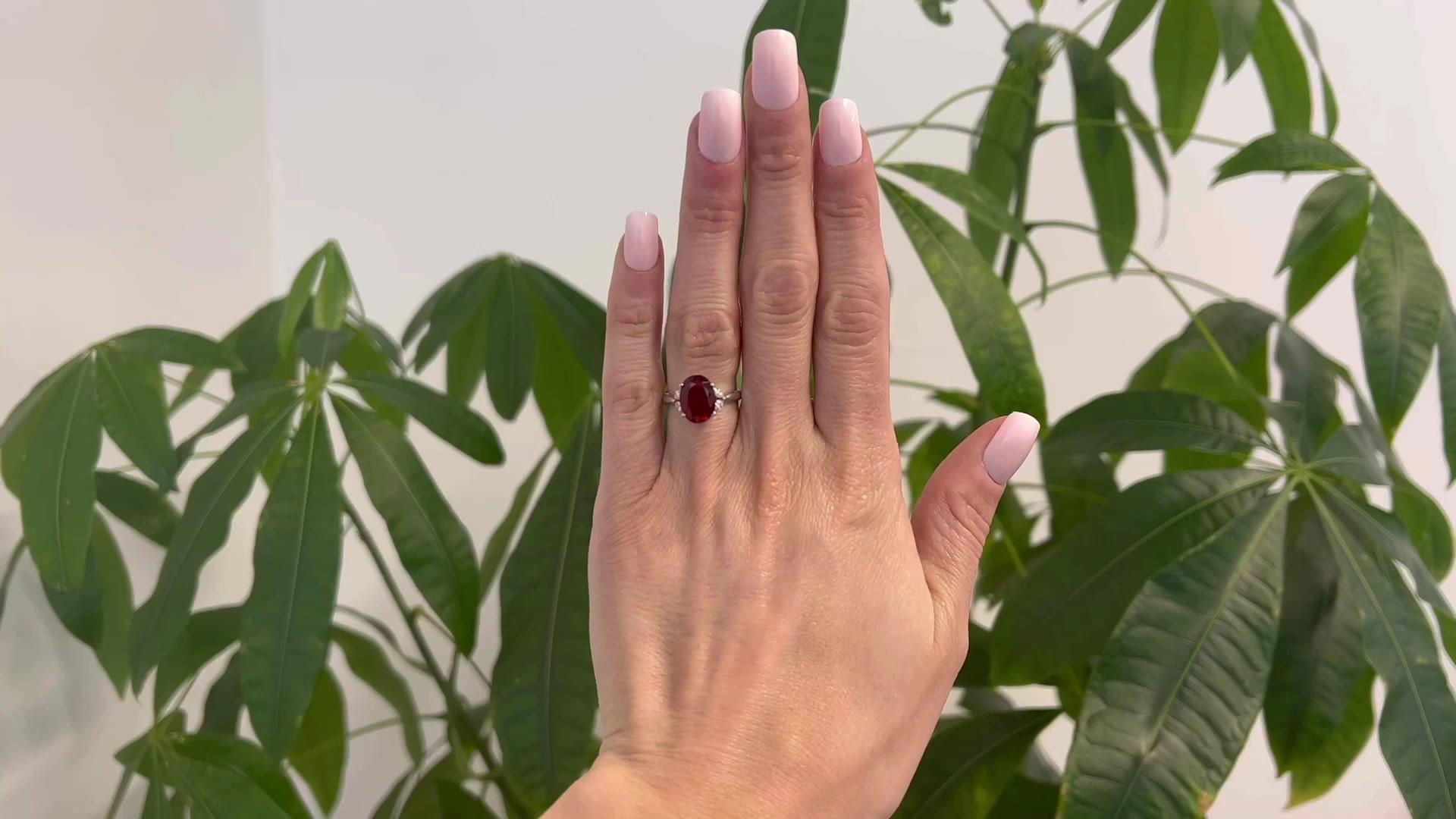 One Vintage 3.55 Carats Red Spinel Diamond Platinum Ring. Featuring one oval mixed cut spinel of 3.55 carats. Accented by four marquise cut diamonds with a total weight of 0.23 carat, graded I color, SI clarity. Crafted in platinum with purity marks