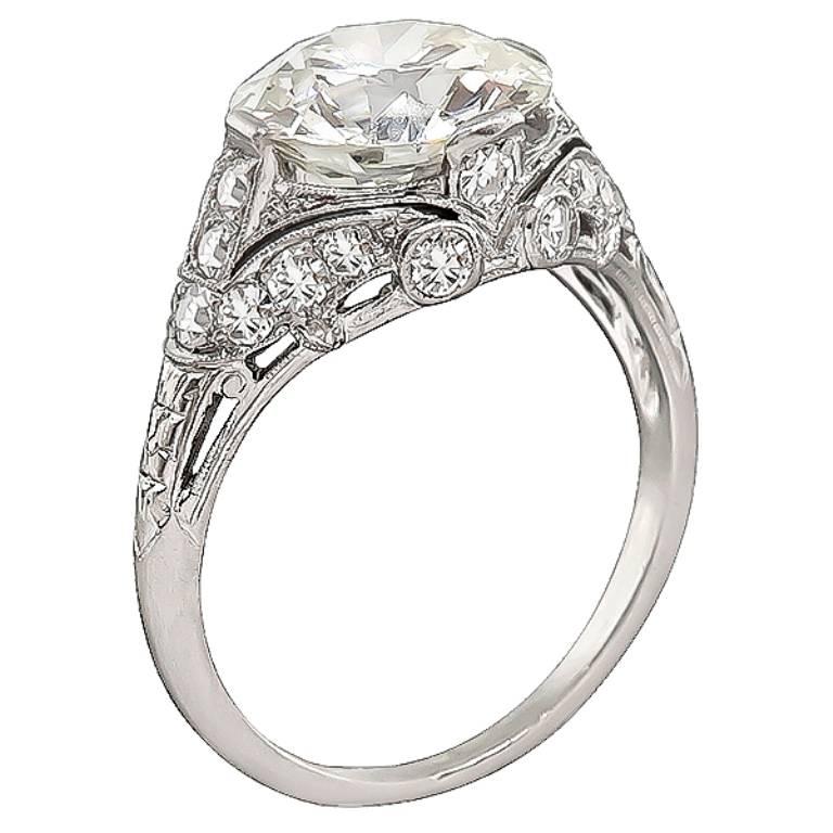 This stunning platinum engagement ring is centered with a sparkling old European cut diamond that weighs 3.59ct. graded J-K color with VS2 clarity. The center diamond is accentuated by dazzling round cut diamonds that weigh approximately 0.50ct.