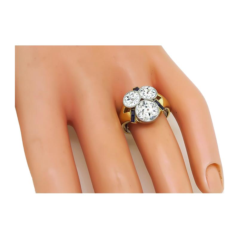 This is a stunning 14k yellow gold and platinum ring from the Retro period. The ring features sparkling old mine cut diamond that weighs approximately 1.60ct. The color of the diamond is H-I with VS clarity. The diamond is accentuated by two
