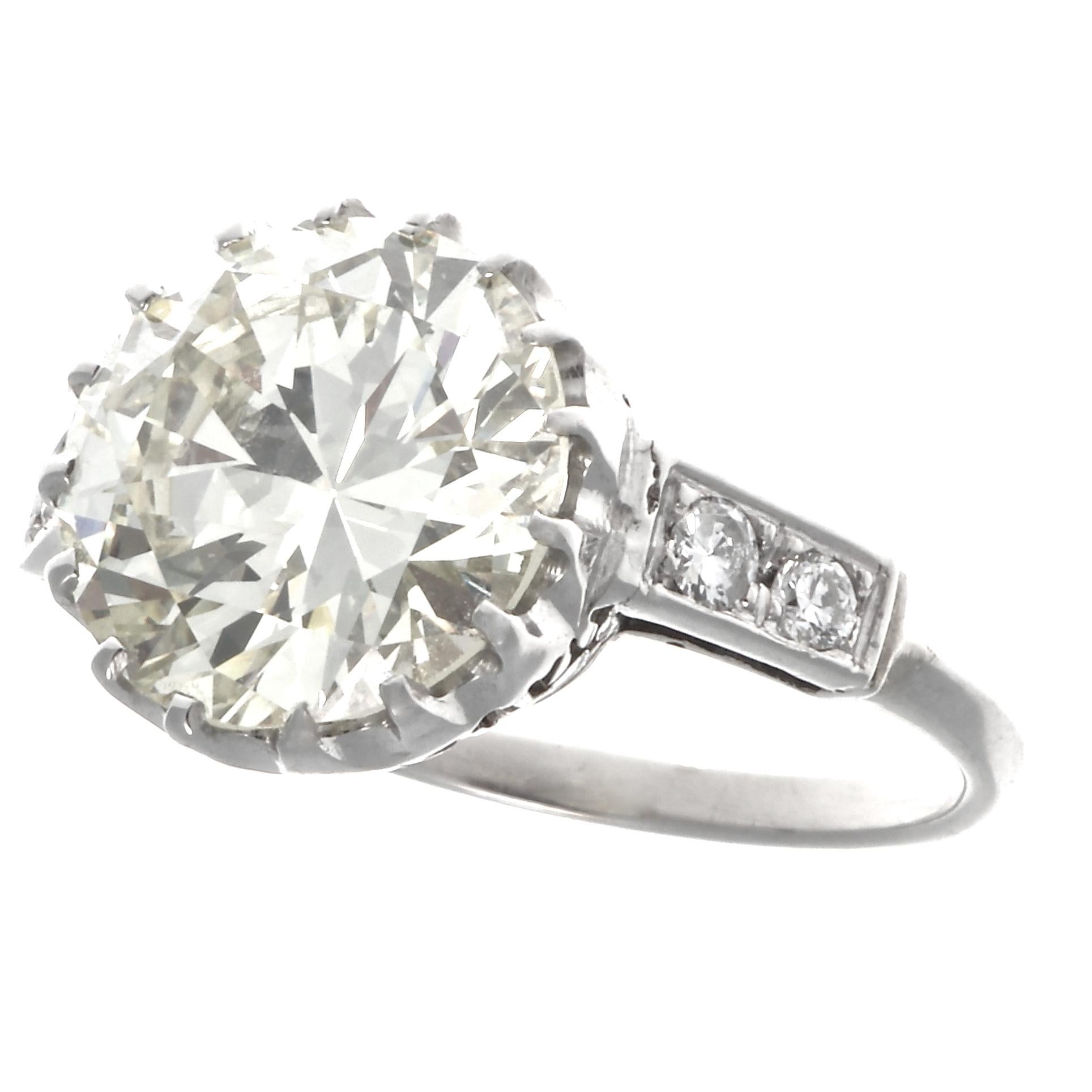Spectacular low profile platinum engagement ring from the 1950's. Featuring a  3.67 round cut diamond, graded Q-R color, VVS clarity. With 4 round brilliant diamonds graded as F-G color, VS clarity. Size 6 1/2 and comes with complimentary sizing if