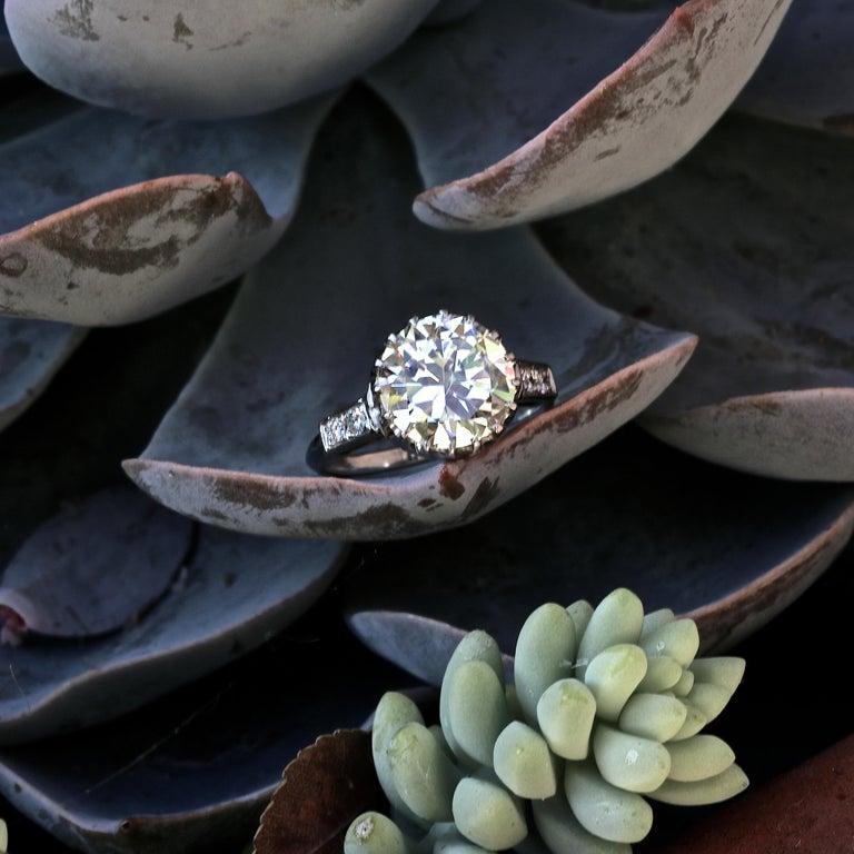 A spectacular low profile ring from the 1950's. If stone size is important to you, this ring offers a larger stone for a reasonable price. The timeless classic beauty features a 3.67 round cut diamond, graded as O,P color, VVS clarity. With 4 round