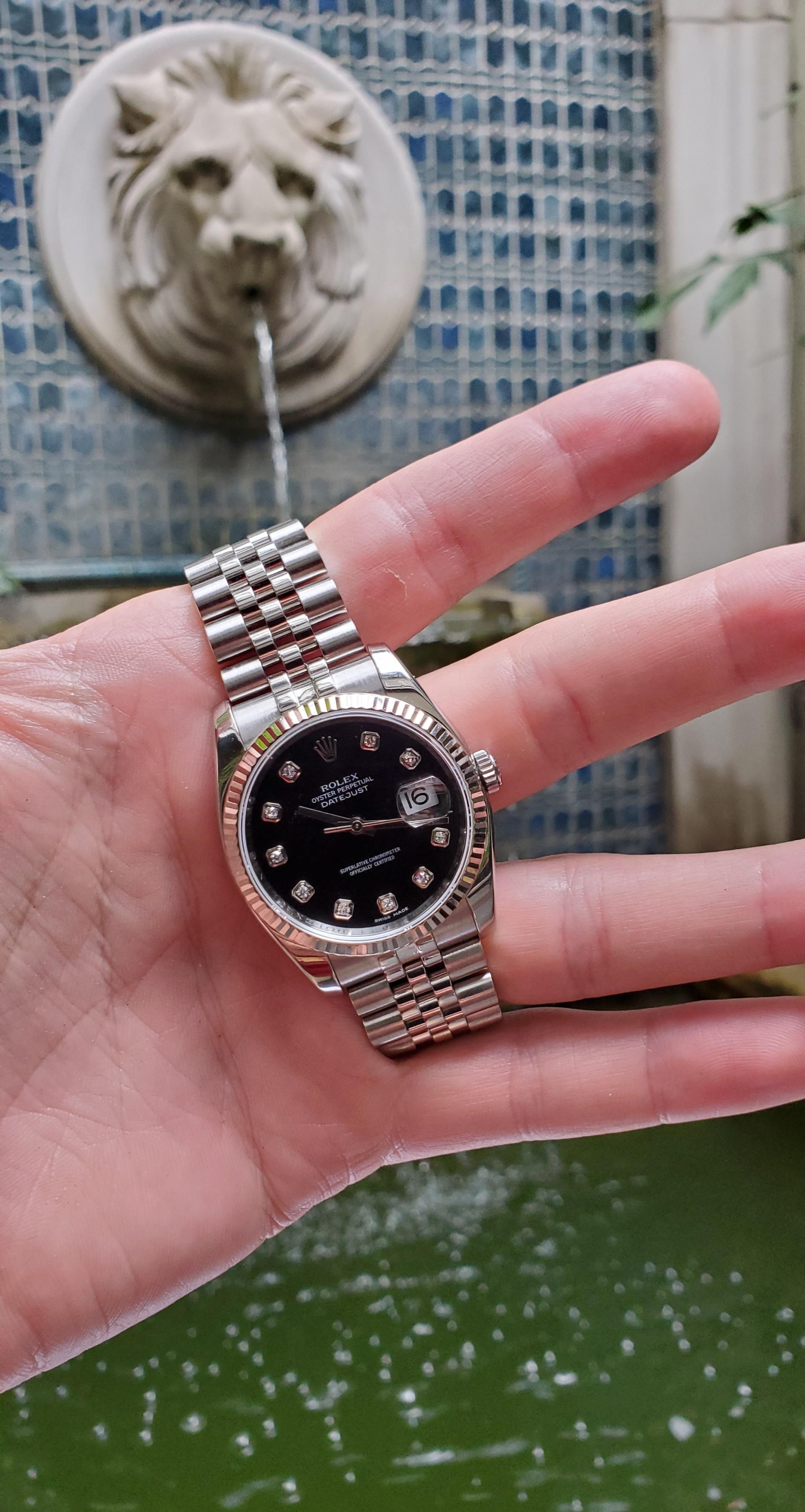 Striking, vintage 36mm Rolex Datejust with factory diamond dial. Black diamond dial has diamonds at the hour markers (slight dial patina at 10 o'clock). There is an 18kt white gold fluted style bezel. The bracelet is a jubilee link with new hidden
