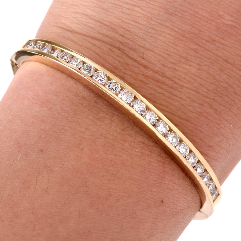 This vintage 1980s bangle bracelet of classic elegance and simplicity is crafted in 18 Karat yellow gold, weighing 22.4 grams and measuring 6 inches around the wrist circumference x 4 mm wide x 4 mm high. The bangle bracelet is enriched with 20