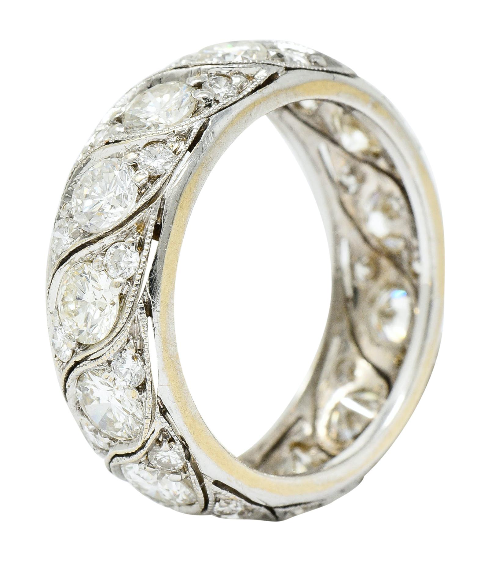Eternity style band with a swiveled eyelet motif throughout, accented by milgrain

Featuring sets of three round brilliant cut diamonds, fully around

Weighing in total approximately 3.78 carats with H to J color and VS to SI clarity

Tested as 14