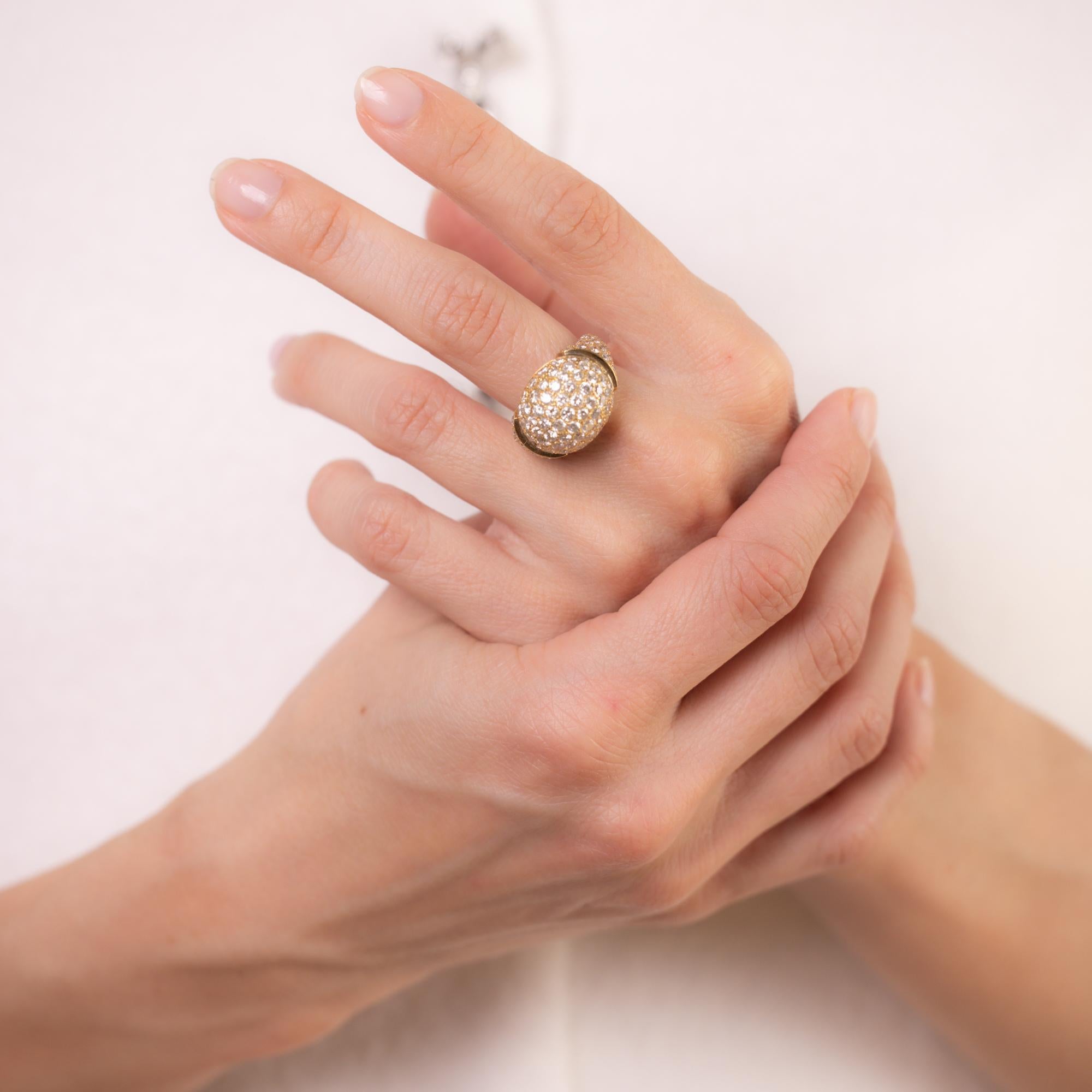 This vintage 18k yellow gold ring dazzles with 126 round brilliant cut diamonds in a breathtaking pavé setting, totaling approximately 3.80 carats, E-F color, VS clarity. A bold yet elegant statement of brilliance and craftsmanship. Circa