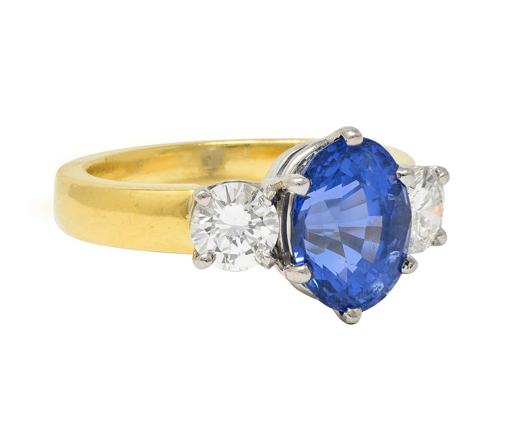 Centering an oval cut sapphire weighing 3.14 carats - transparent medium blue
Natural Sri Lankan in origin with no indications of heat treatment
Prong set in platinum and flanked by round brilliant cut diamonds 
Weighing approximately 0.72 carat