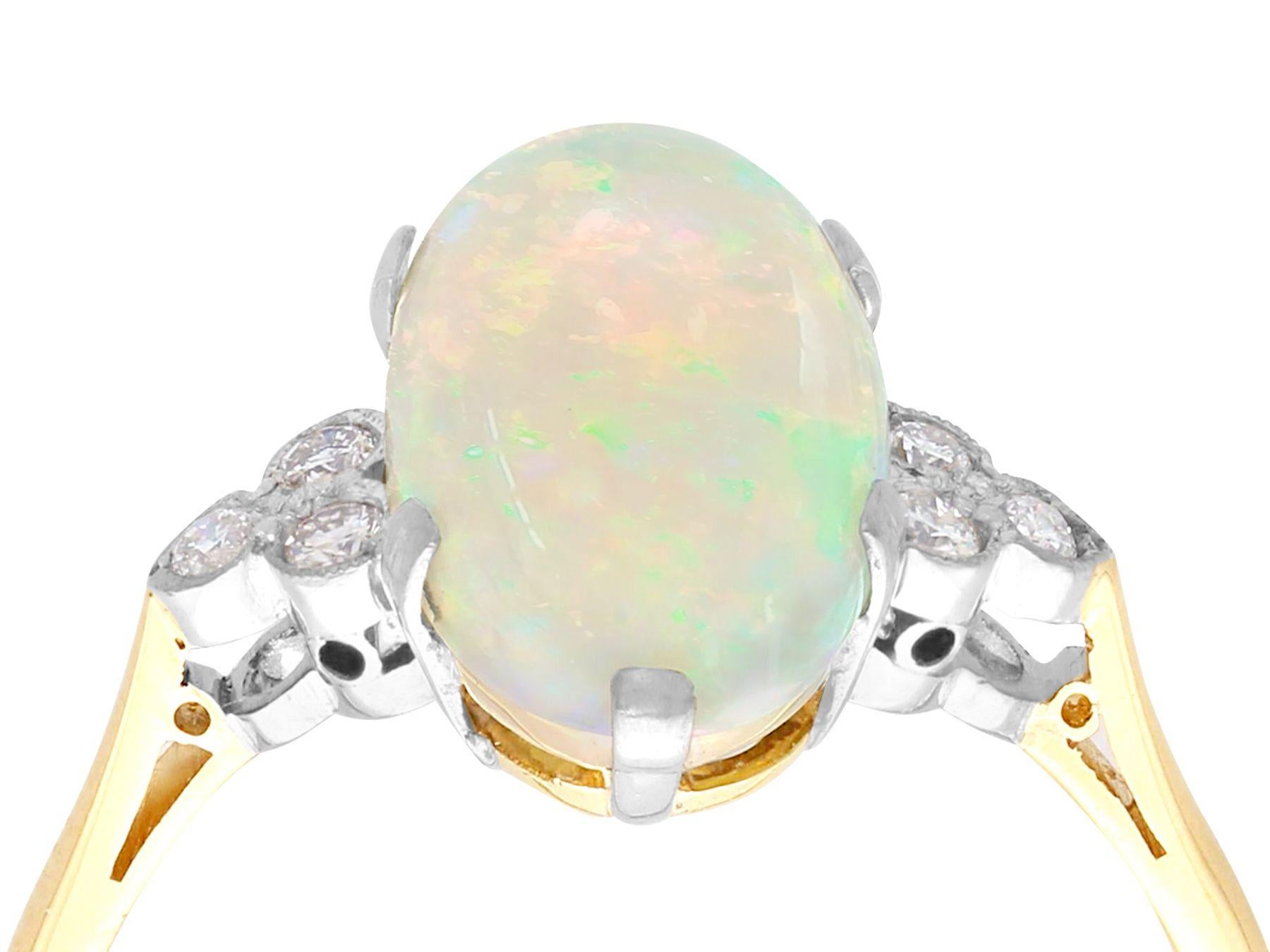 A stunning, fine and impressive vintage 3.88 Carat opal and 0.18 Carat diamond, 18 karat yellow gold and platinum set dress ring; part of our diverse vintage jewelry and estate jewelry collections.

This stunning vintage opal and diamond ring has