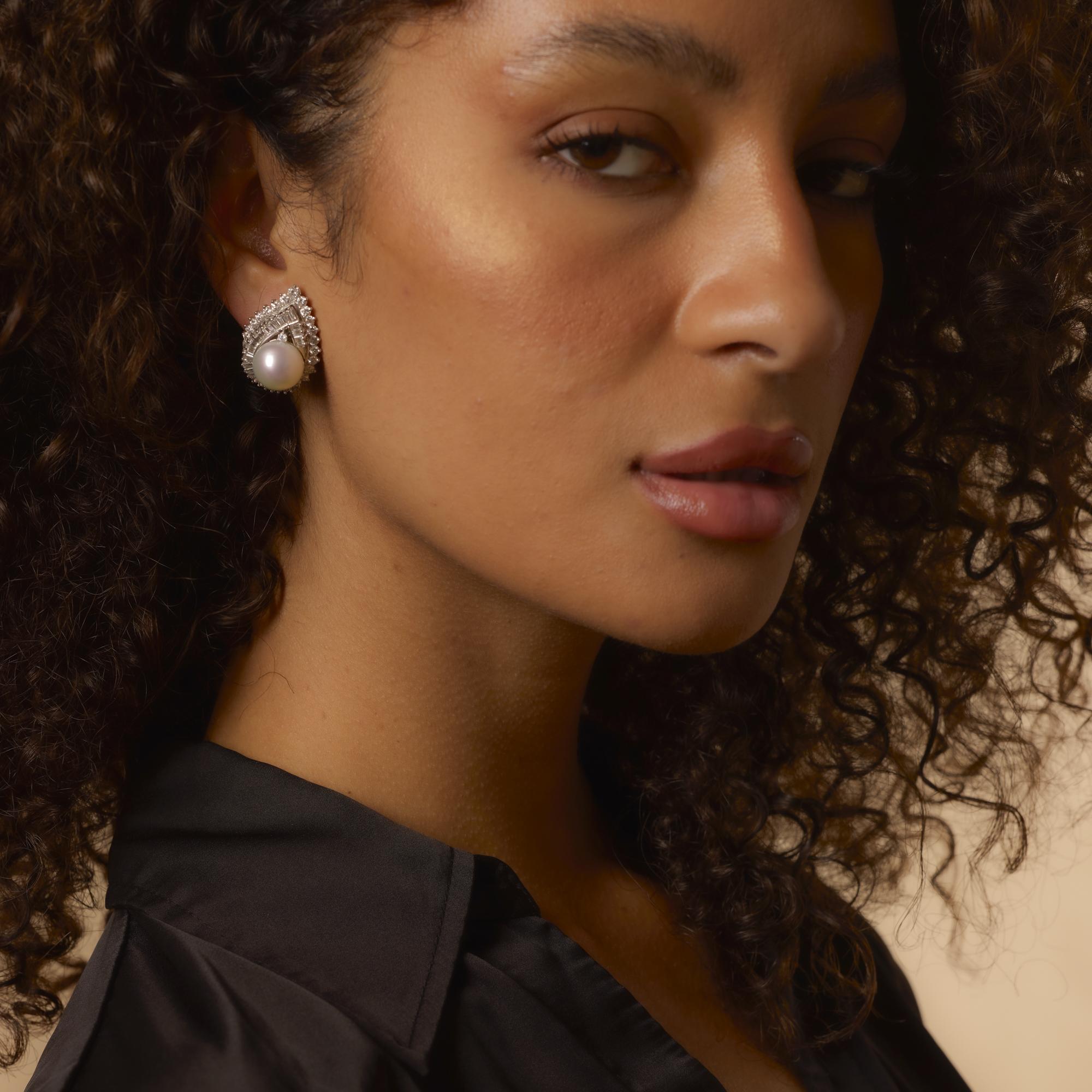These bold vintage 1980's earrings feature luminous pearls framed by 5 carats of dazzling diamonds in finely crafted 18k white gold.