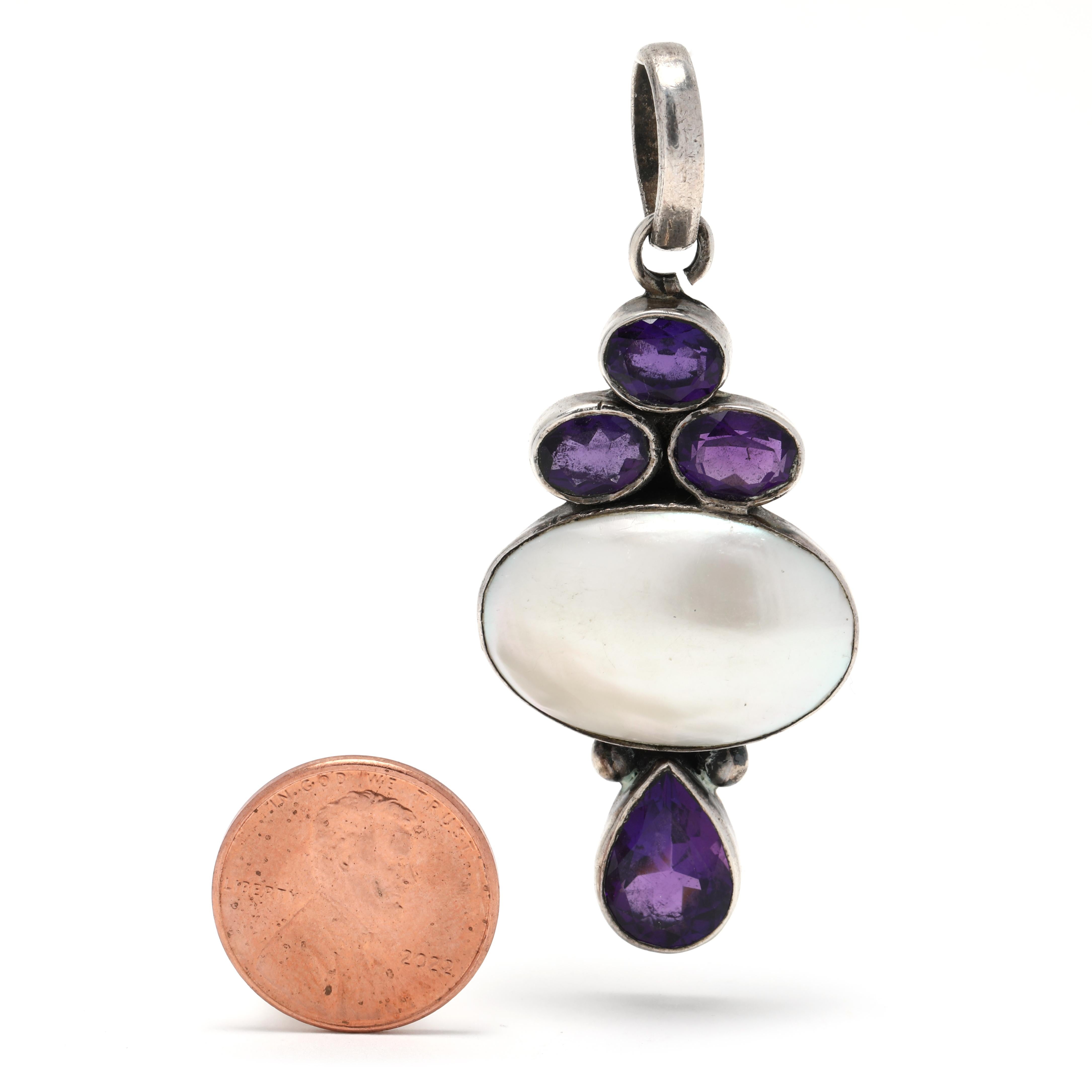 This stunning vintage pendant is crafted in sterling silver and showcases a 3ctw amethyst and mabé pearl. The large mabé pearl is suspended from an intricate sterling silver setting and hangs 2.5 inches long. This eye-catching piece is perfect for