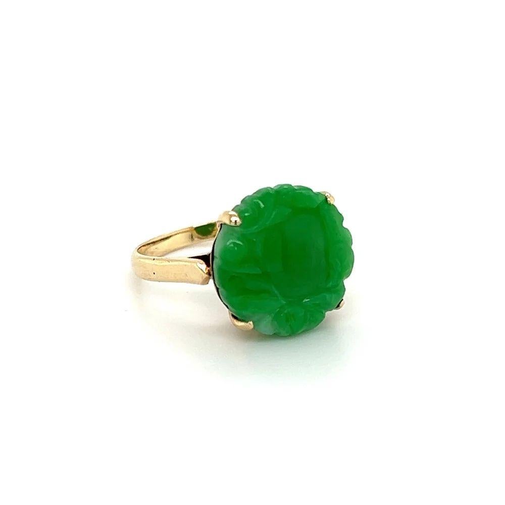 Simply Beautiful! Carved Jade Gold Solitaire Cocktail Ring. Centering a Hand set securely nestled 4 Carat Round Carved Jade Jadeite. Hand crafted 14K Yellow Gold Filigree mounting. In excellent condition and recently professionally cleaned and