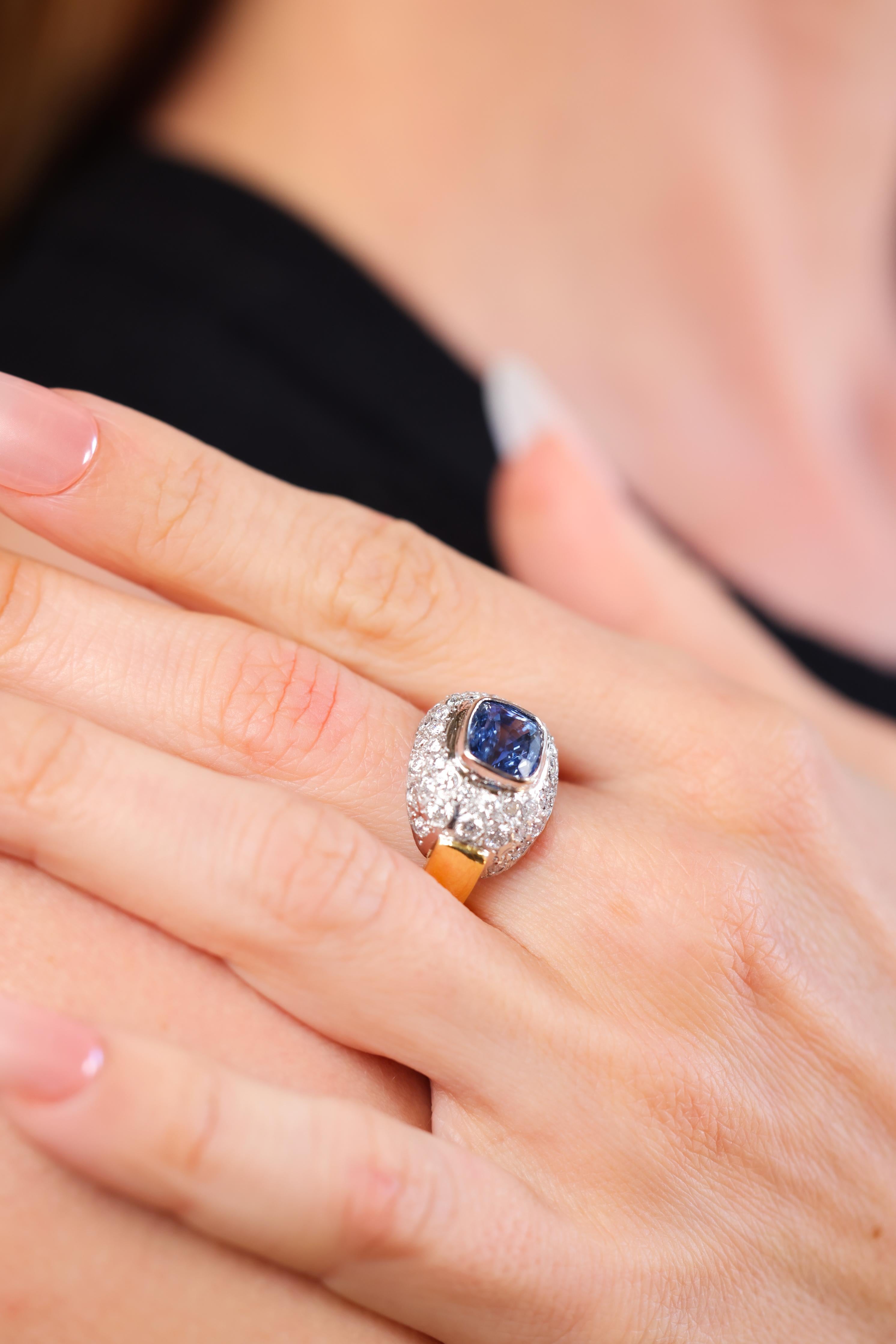 cushion cut cornflower blue sapphire weighing approximately 4 carat
Acccented by 42 round brilliant cut diamonds weighing approximately 0.80 carats 
G-H color 
VS clarity 
18k white and yellow gold 
Circa 1980s 
Rings size 7 and can be resized 
9.9