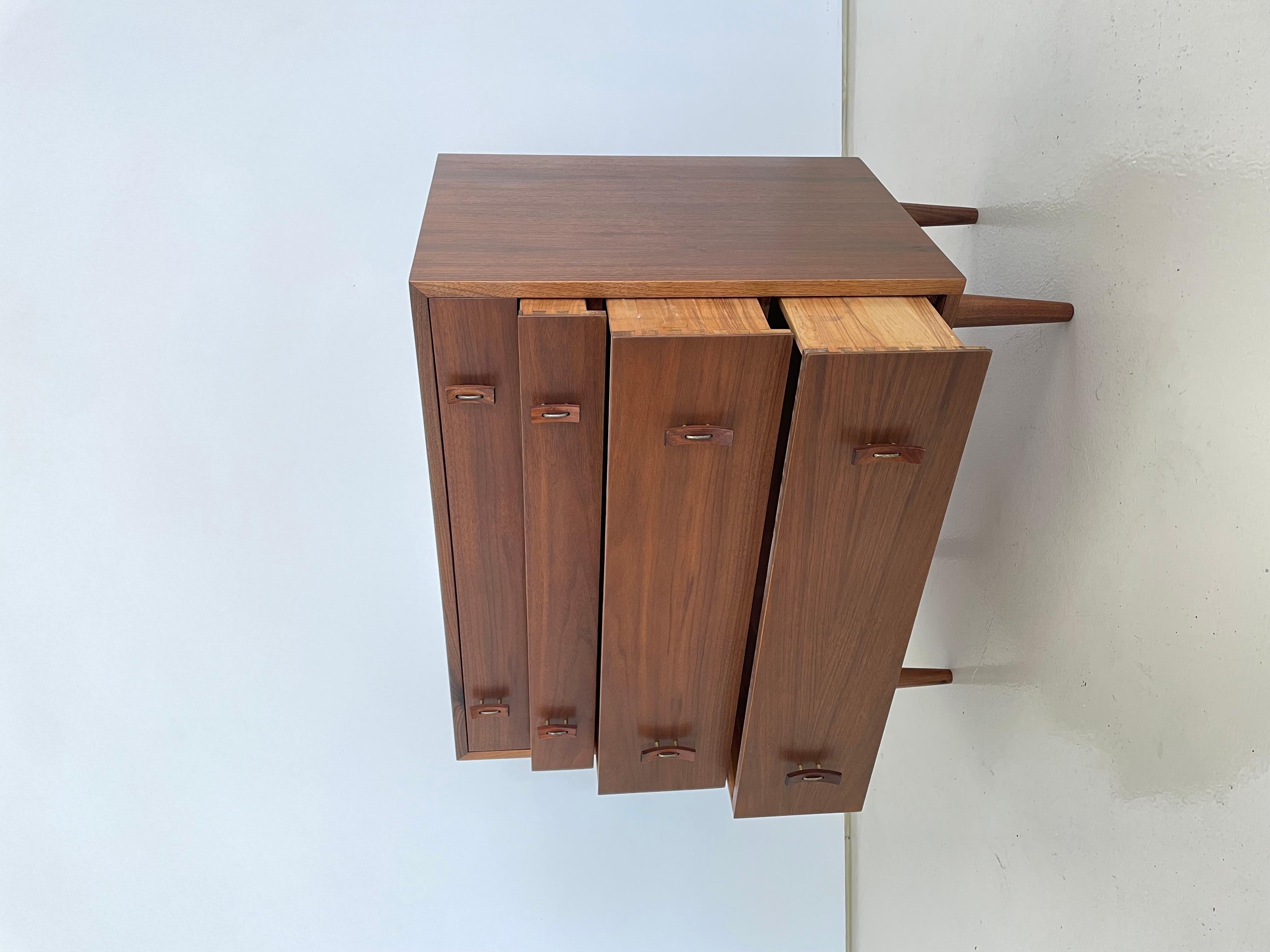 Manufactured in the US in the 1950’s

Solid Walnut legs with Walnut veneer drawer and case facades

Solid wood dovetail drawer construction

This collectible dresser is in the original finish and maintains all original hardware.

Sourced in