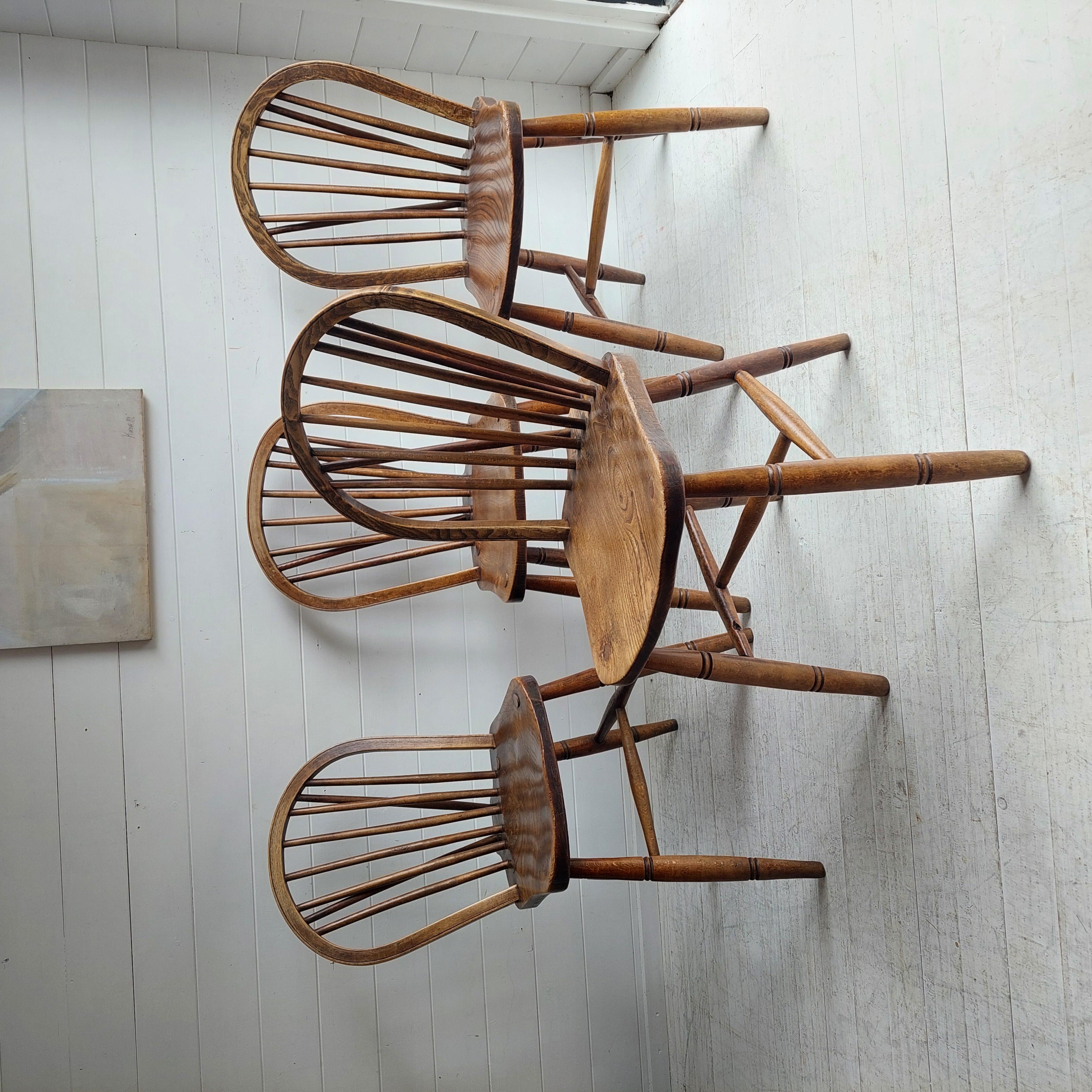 This is a set of four early Mid Century Windsor chairs from High Wycombe. 
Hoop back dining chairs with bobbin tail circa 1942. 

maker's stamp to the underside of the seat of O.Haines, High Wycombe
Dated 1942
Initials Stamps to the rear wedge,
