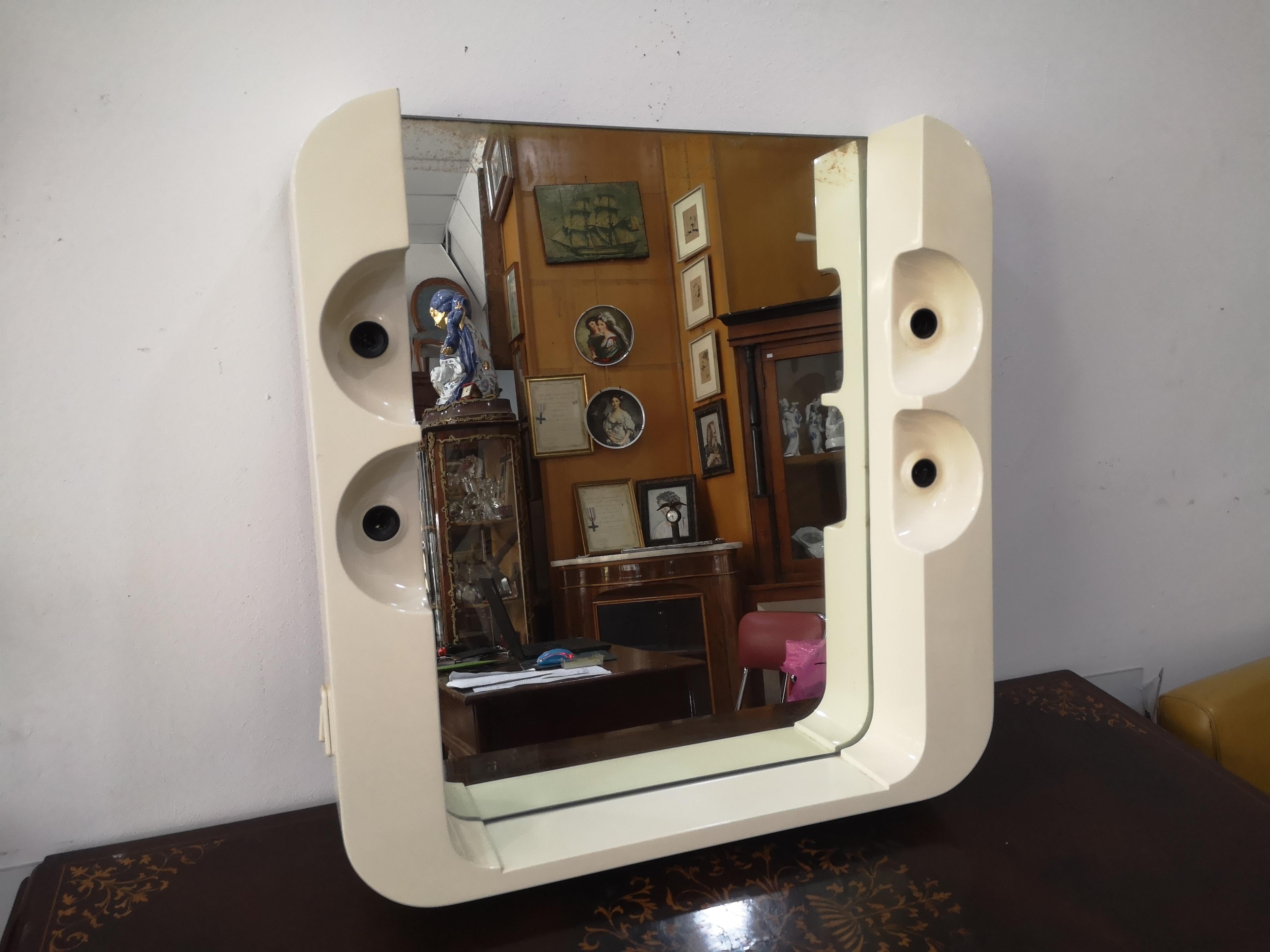Miroir de salle de bain vintage en plastique blanc à 4 lumières
des années 1970 en bon état compatible
avec l'usure du temps.
Les mesures du miroir :
Hauteur :  cm 60
Largeur : cm 58
Épaisseur : 10 cm

Expédition précise.