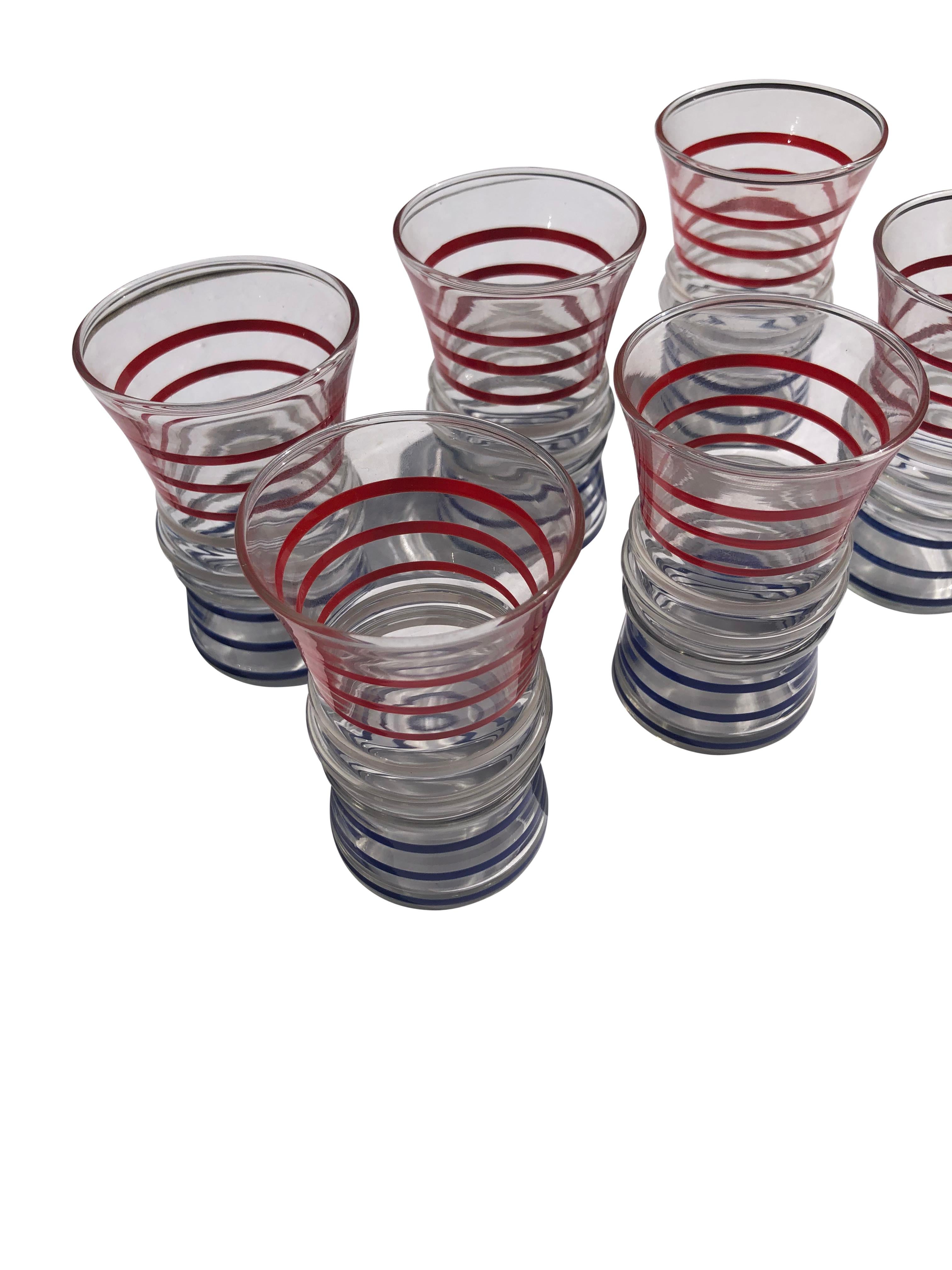 Set of 6 festive and patriotic 4 oz. tumblers decorated with raised bands each with  3 blue bands, 3 white bands, and 3 red bands. Glasses are flared, measuring 2.375” at top and 2” at bottom. 
