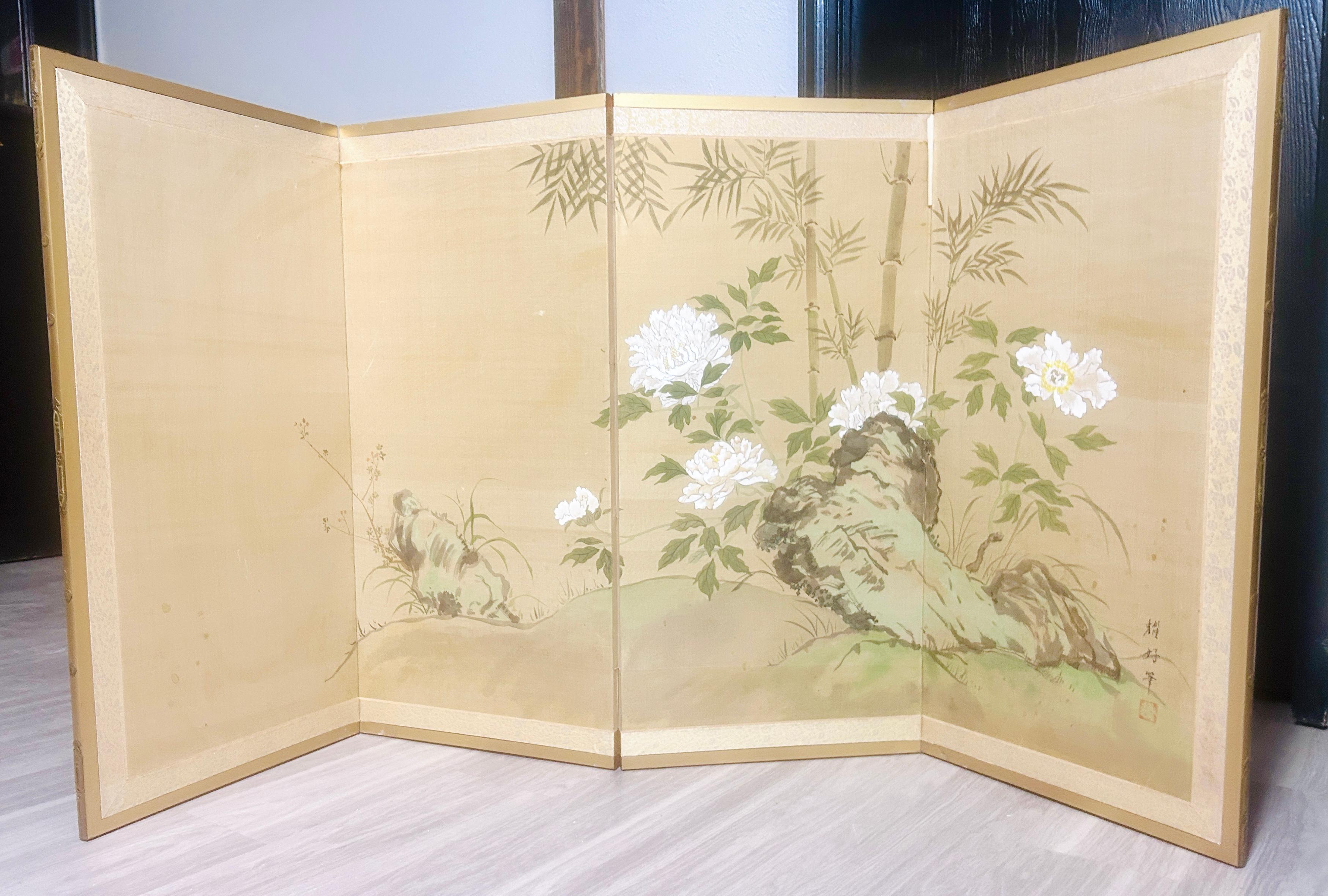 This early 20th century Asian folding screen, or byobu, features intricate hand-painted flowers and leaves in a vibrant multi-color palette. Made from mixed materials, this antique original piece showcases traditional Asian craftsmanship and design.
