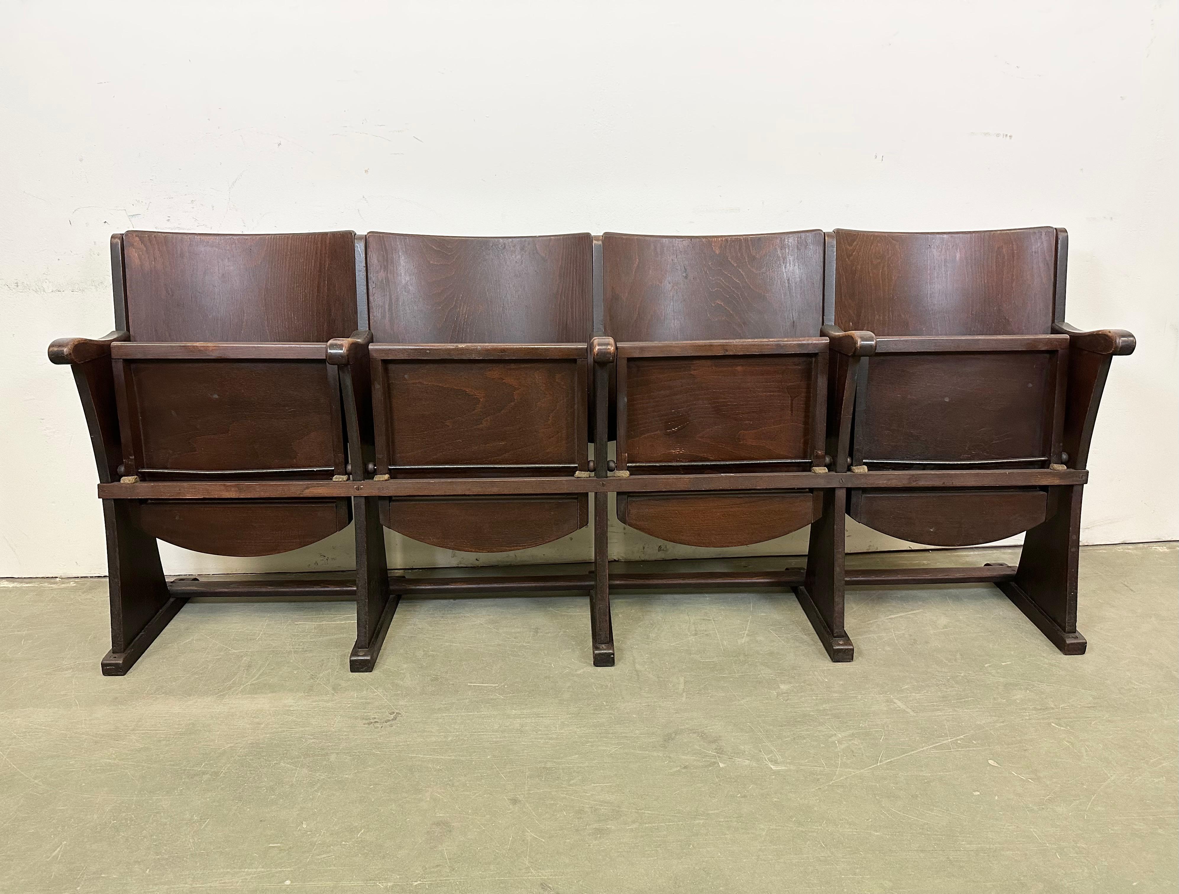 This four-seat cinema bench was produced by Thonet in former Czechoslovakia during the 1930s-1950s. The chairs are stable and can be placed anywhere. It is completely made of wood (partly solid wood, partly plywood). The seats fold upwards. The