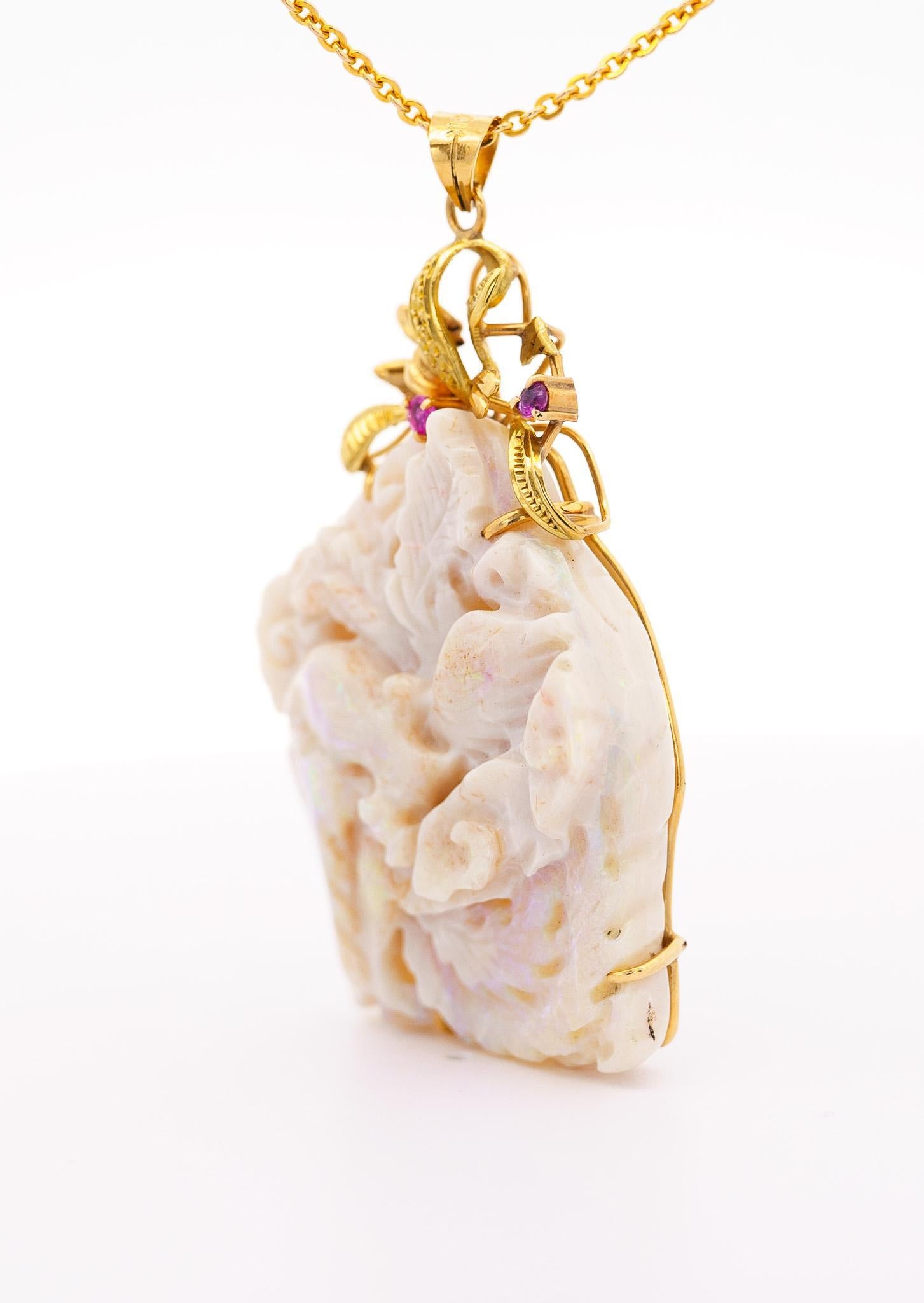 Vintage 40 Carat Natural Carved Opal in 14K Yellow Gold Floral Frame Pendant Necklace. The opal is carved to perfection and full of luster. Fixed with a 30 inch 14k solid gold cable chain and 14k gold frame. A one of a kind vintage masterpiece that
