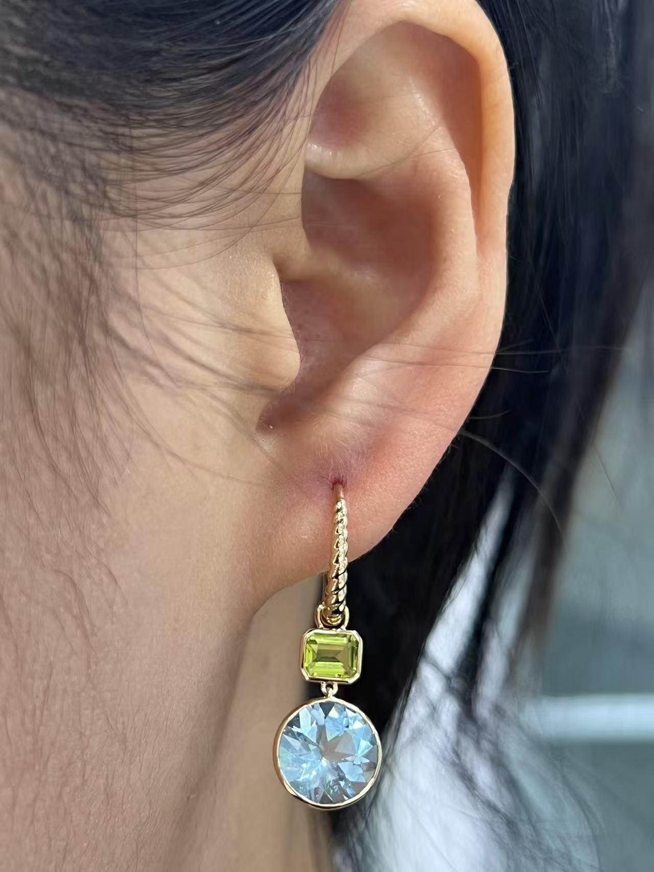 Add a touch of elegance and tranquility to your jewelry collection with these stunning 14K gold dangle earrings.  Featuring enchanting 4.08-carat aquamarines, these earrings exude a serene blue hue reminiscent of crystal-clear waters.  The