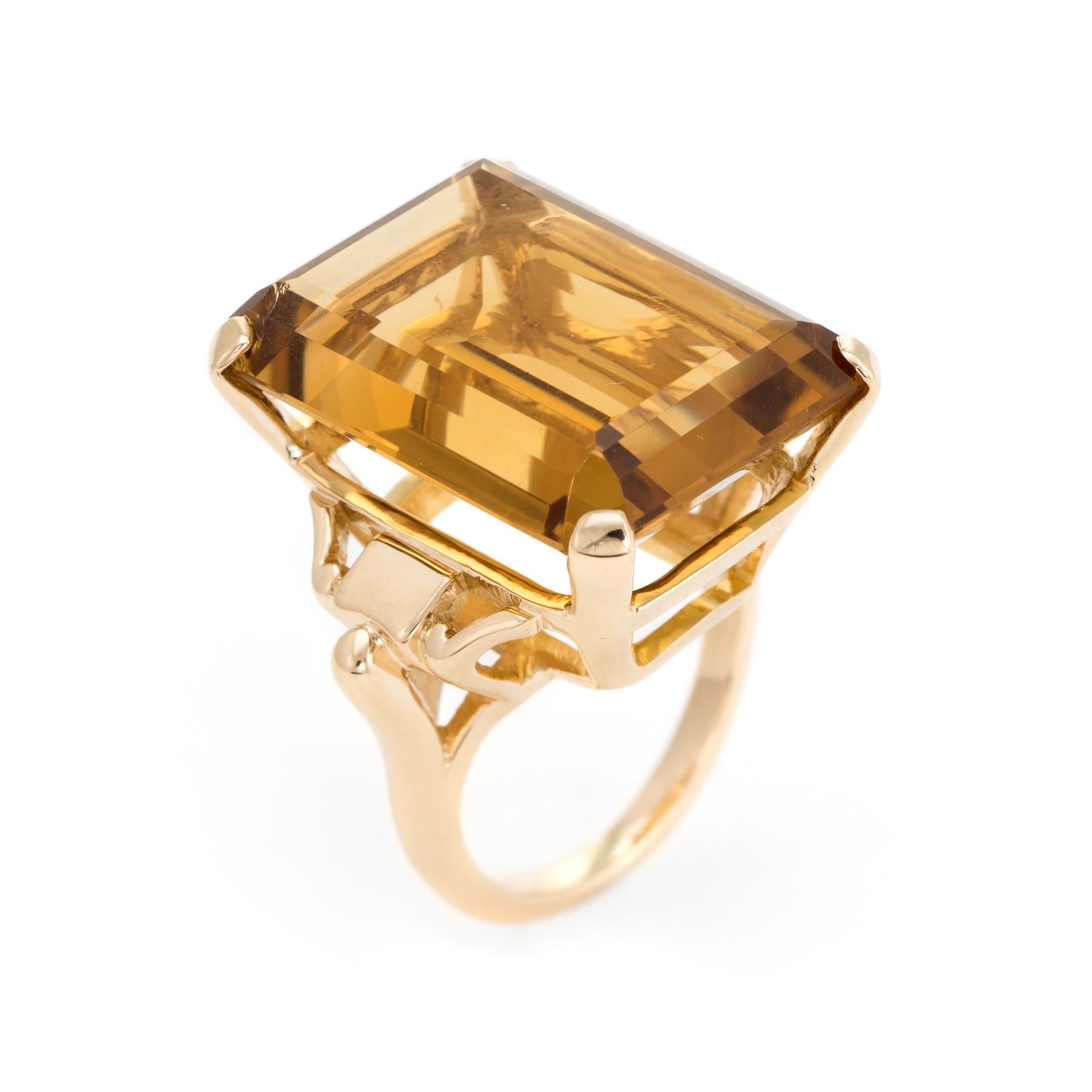 Finely detailed vintage citrine cocktail ring (circa 1950s to 1960s), crafted in 14 karat yellow gold. 

Emerald cut citrine measures 22mm x 16mm (estimated at 40 carats) is set into the mount. The citrine is in excellent condition and free of